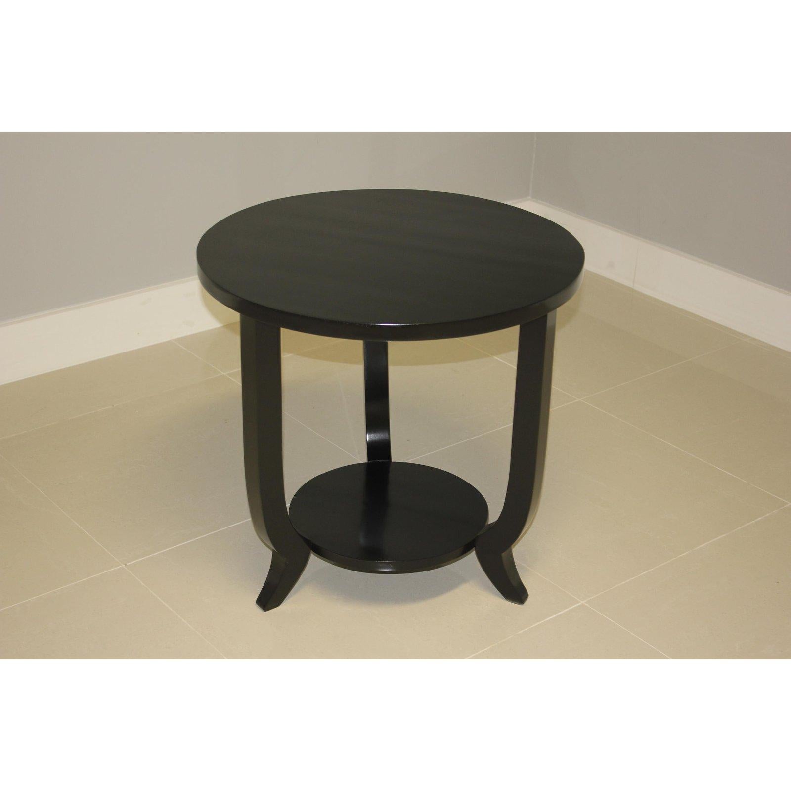 Beautiful French Art Deco period black ebonized side table or coffee table, circa 1940s. The table is ebonized with a French lacquer finish. It is ideal next to a chair or for use as a bedside table. We bought this item in Monaco. Size: Diameter