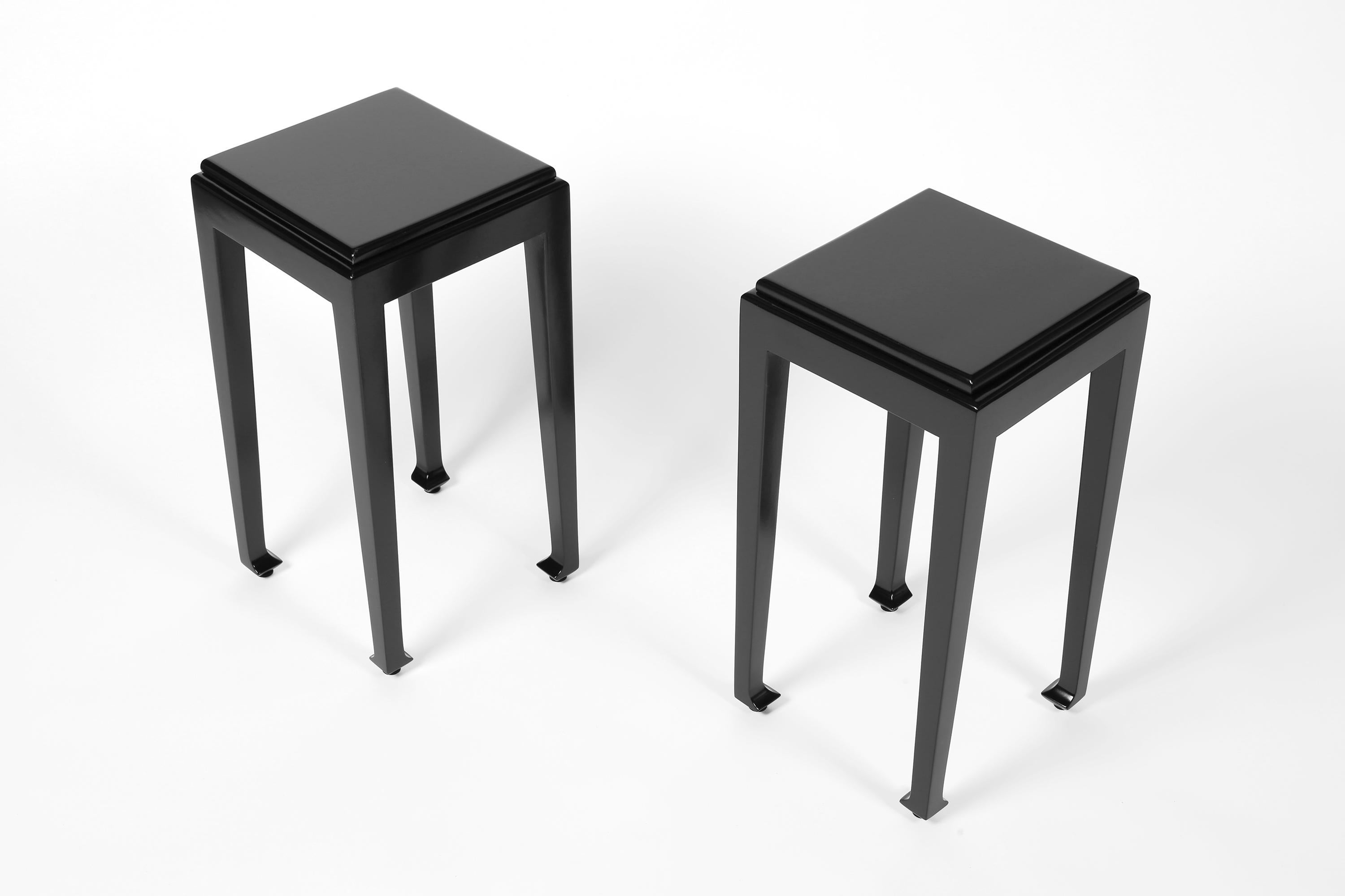 A pair of Art Deco carved timber side tables attributed to Paul Poiret for Atelier Martine. The stepped top and shaped frieze sitting above slender legs, with typical eastern influence to the feet. Entirely finished in new glossy black lacquer. 