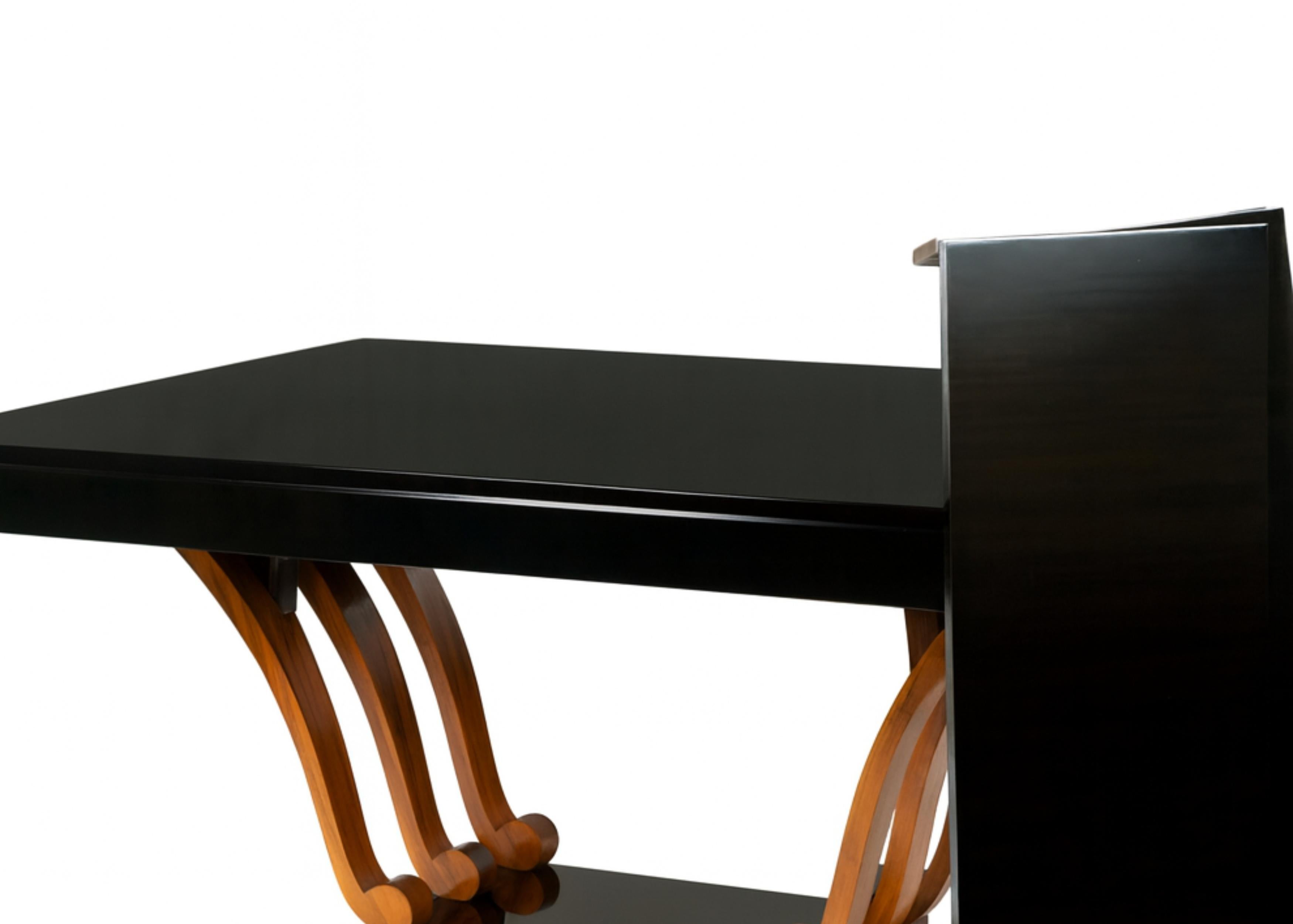 This stunning french black color dining table (1930s) features a classic varnished parquetry dining table with rounded legs and an harplike structure, with extensions, a fine example of geometry and curvature in the Art Deco Period.

Height: 75 cm