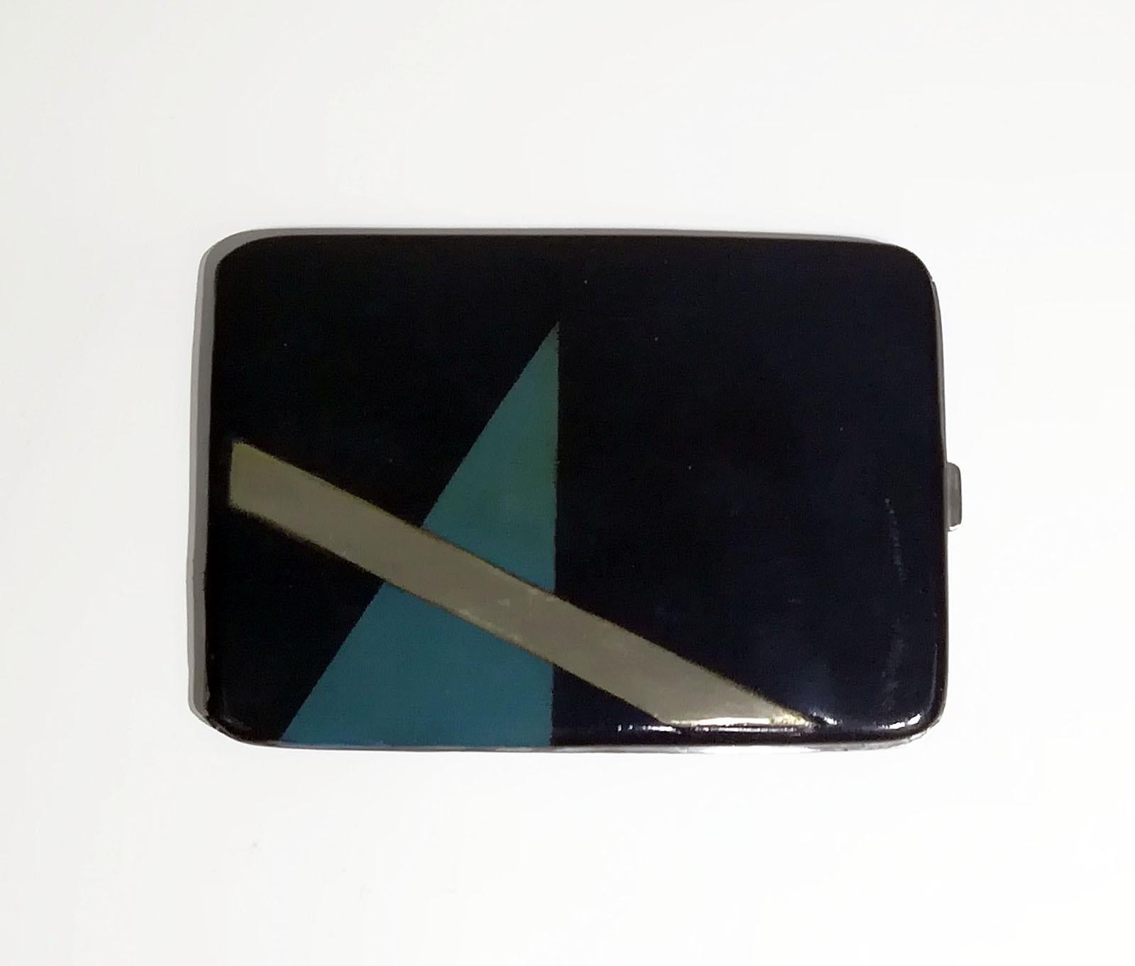 Rectangular black lacquered silver cigarette case with geometric decoration on the side. 
This is a very rare good looking and functional piece of collectible smoking equipment.
 