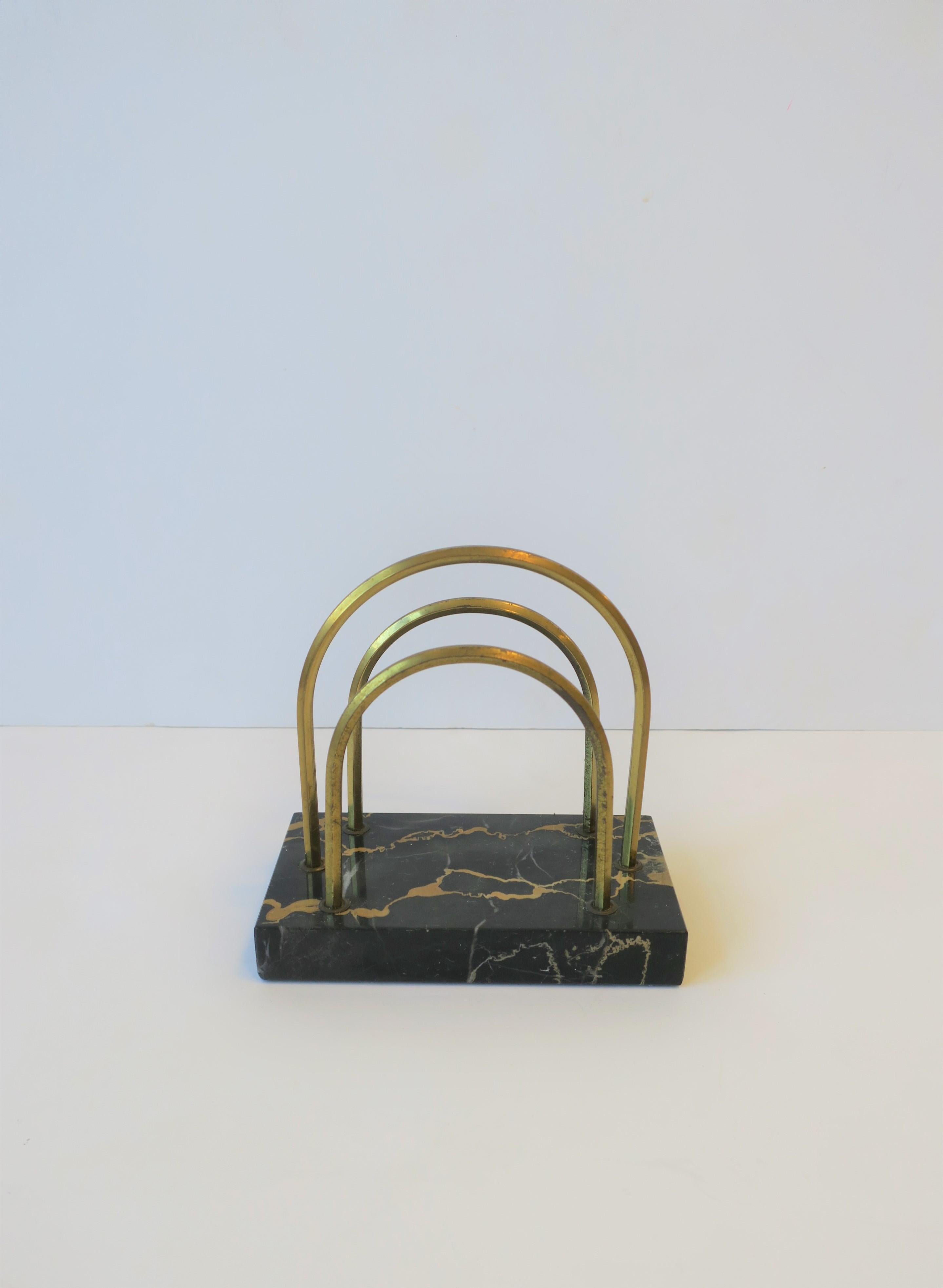 A beautiful and substantial French modern Art Deco black marble and brass desk letter holder, circa 1930s, France. Marble is predominantly black with tan veining; this marble is aka as 'Portoro Marble'.

Measurements include: 3