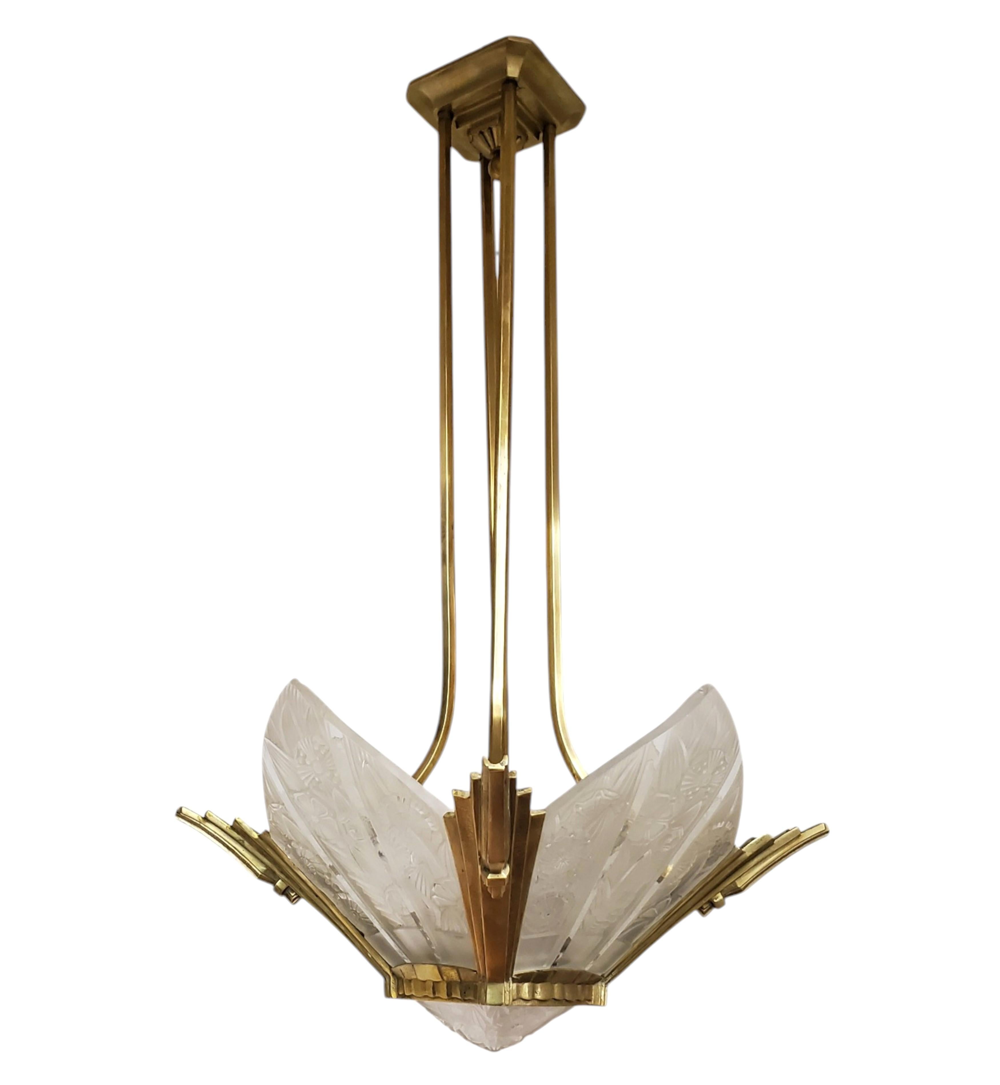 An original French Art Deco signed chandelier featuring four pointed arch shaped molded and frosted art glass panels of stylized floral motif intersected by clear vertical bands, along with an original matching small square molded center