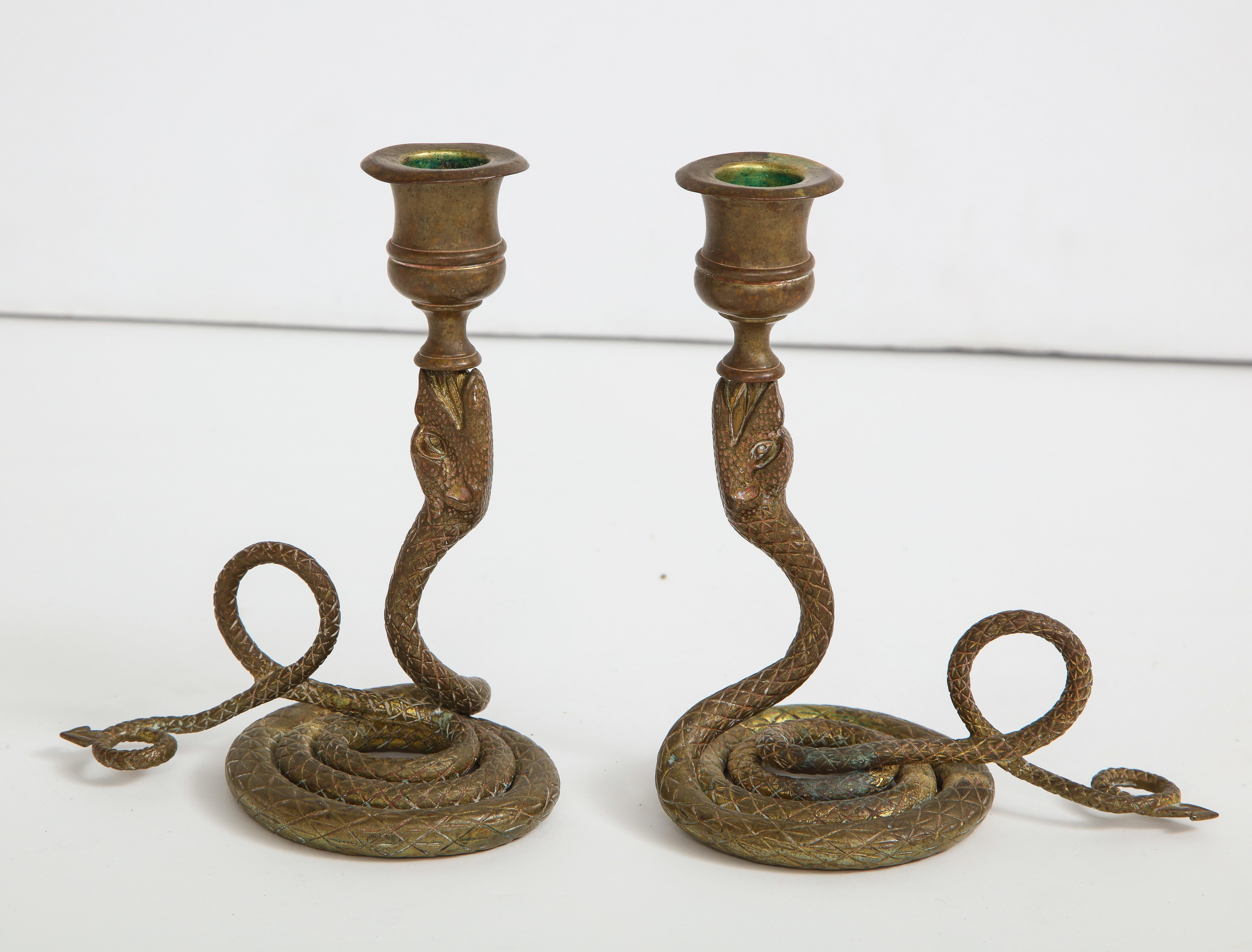 Exquisite pair of Art Deco brass Cobra candlesticks with scaled and coiled bodies.