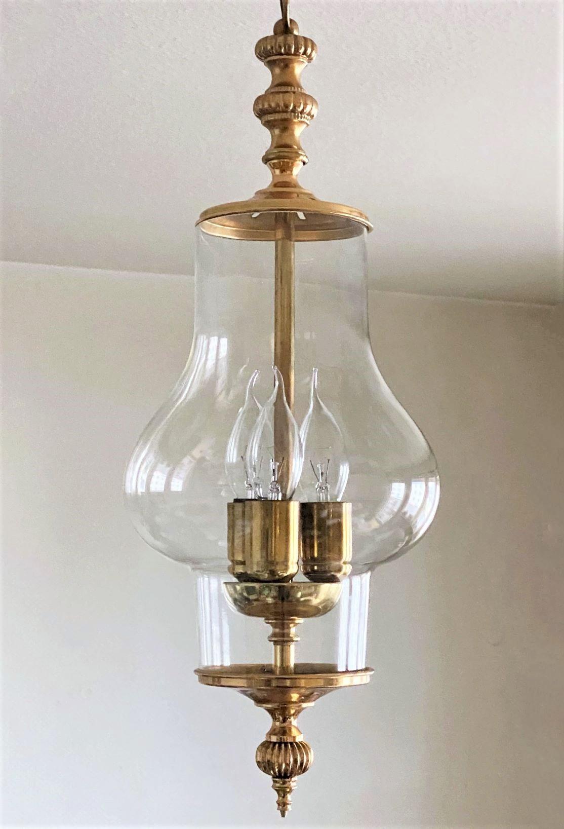 One of kind Art Deco hand blown clear crystal lantern with a central three-bulb candelabra cluster and elegant brass mounts, France, 1930-1939. It takes 3 Edison E-14 screw bulbs. This beautiful piece is in fine vintage condition,