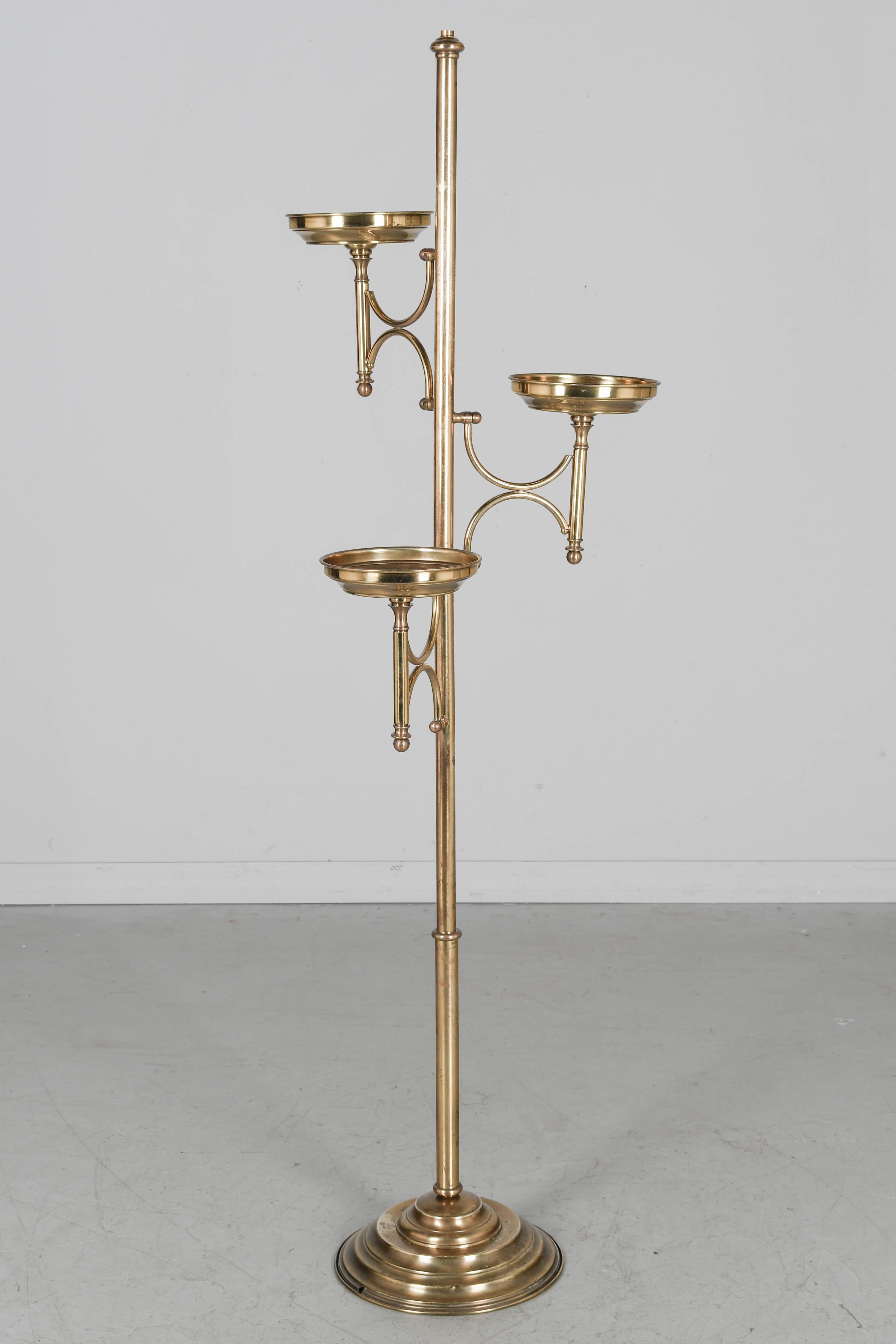 A French Art Deco solid brass plant stand with circular base, sturdy pole and three trays to display potted plants. In good condition with nice patina. May be polished to a high shine. Circa 1920-1940
Overall dimensions: 62.5
