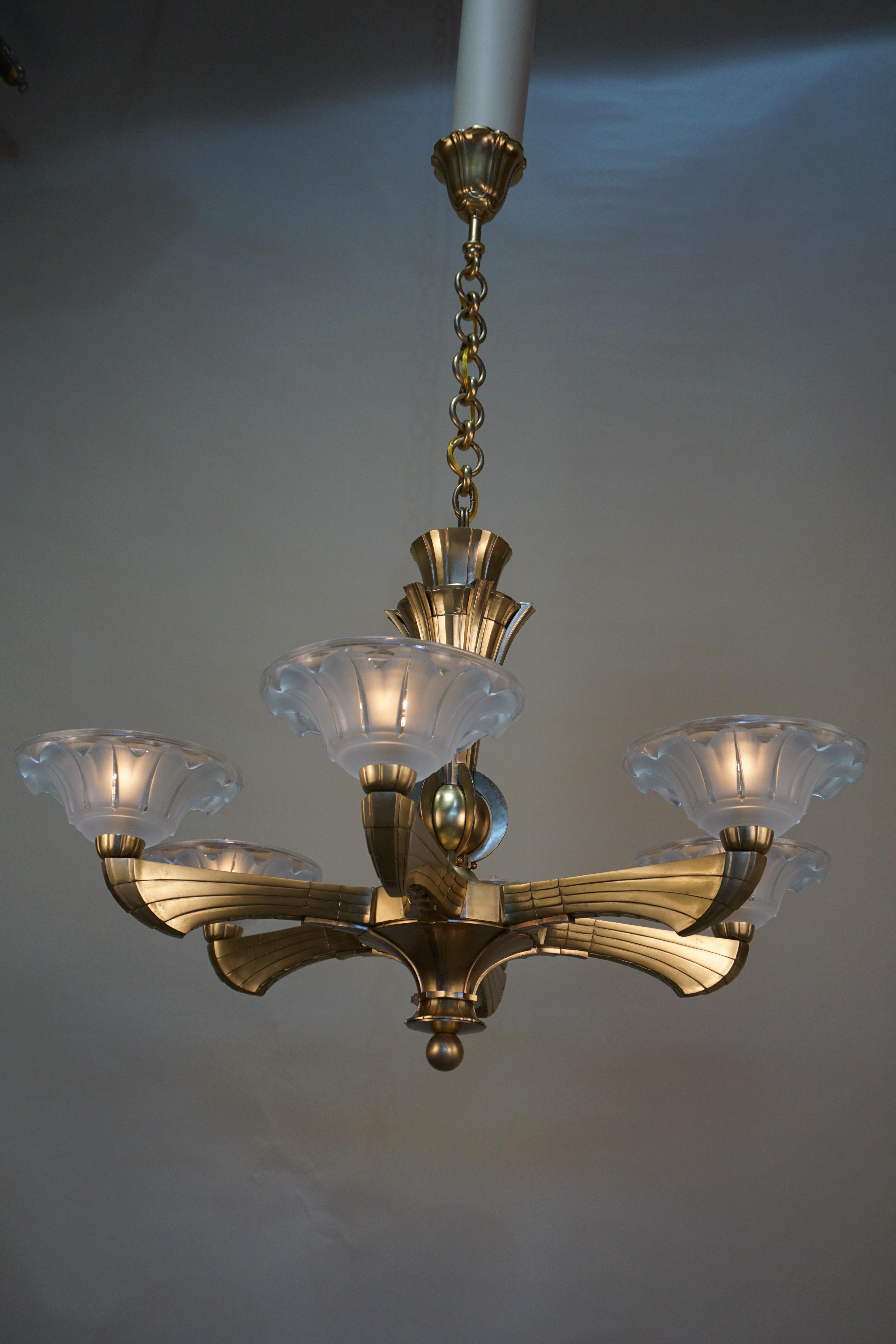 Heavy six-arm cased bronze Art Deco chandelier with clear frost glass shades.
This chandelier has 46