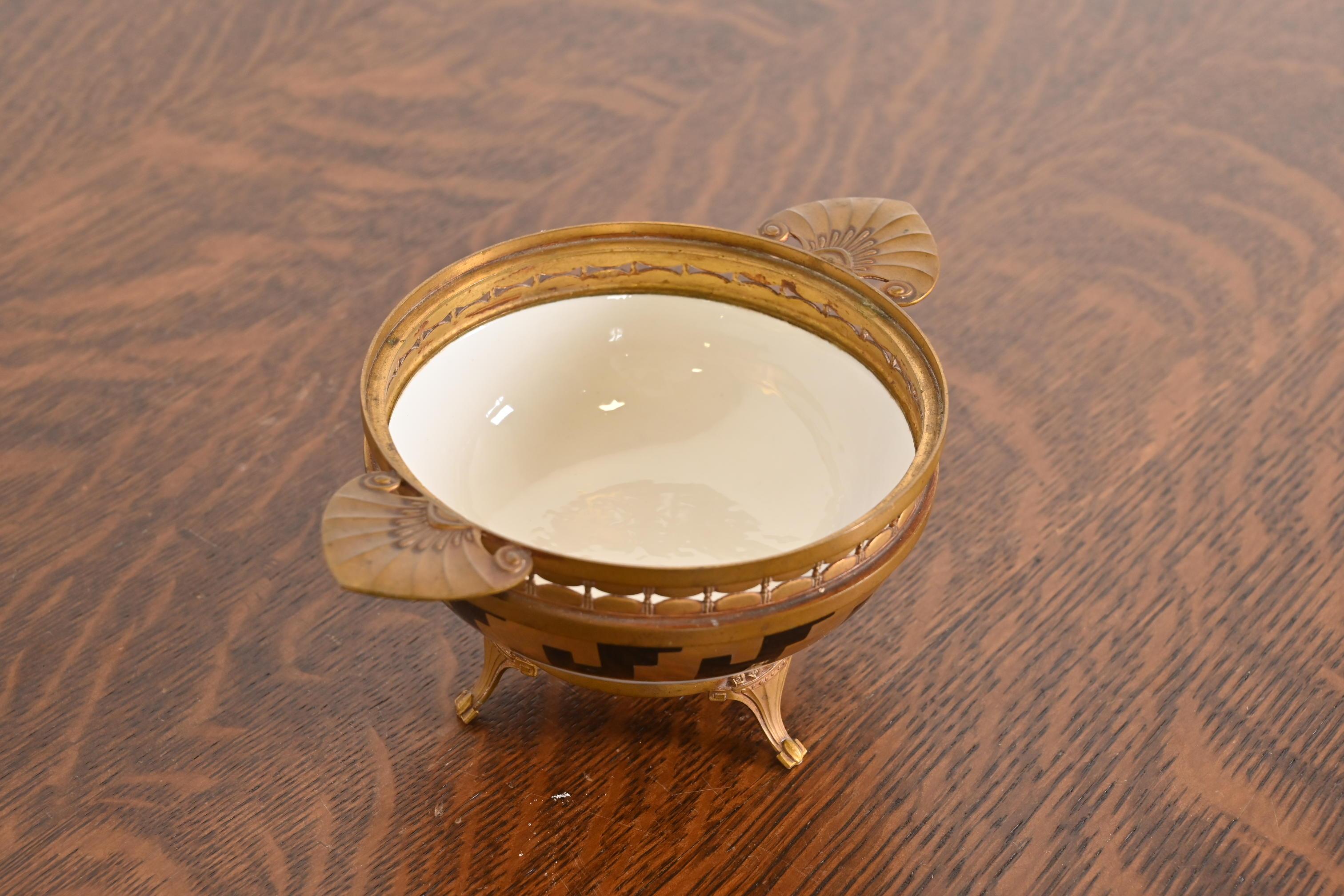 A gorgeous antique French Art Deco bronze and porcelain footed bowl or compote dish

In the manner of Tiffany & Co.

By A. Hnazary

France, Circa 1920s

Measures: 7.13