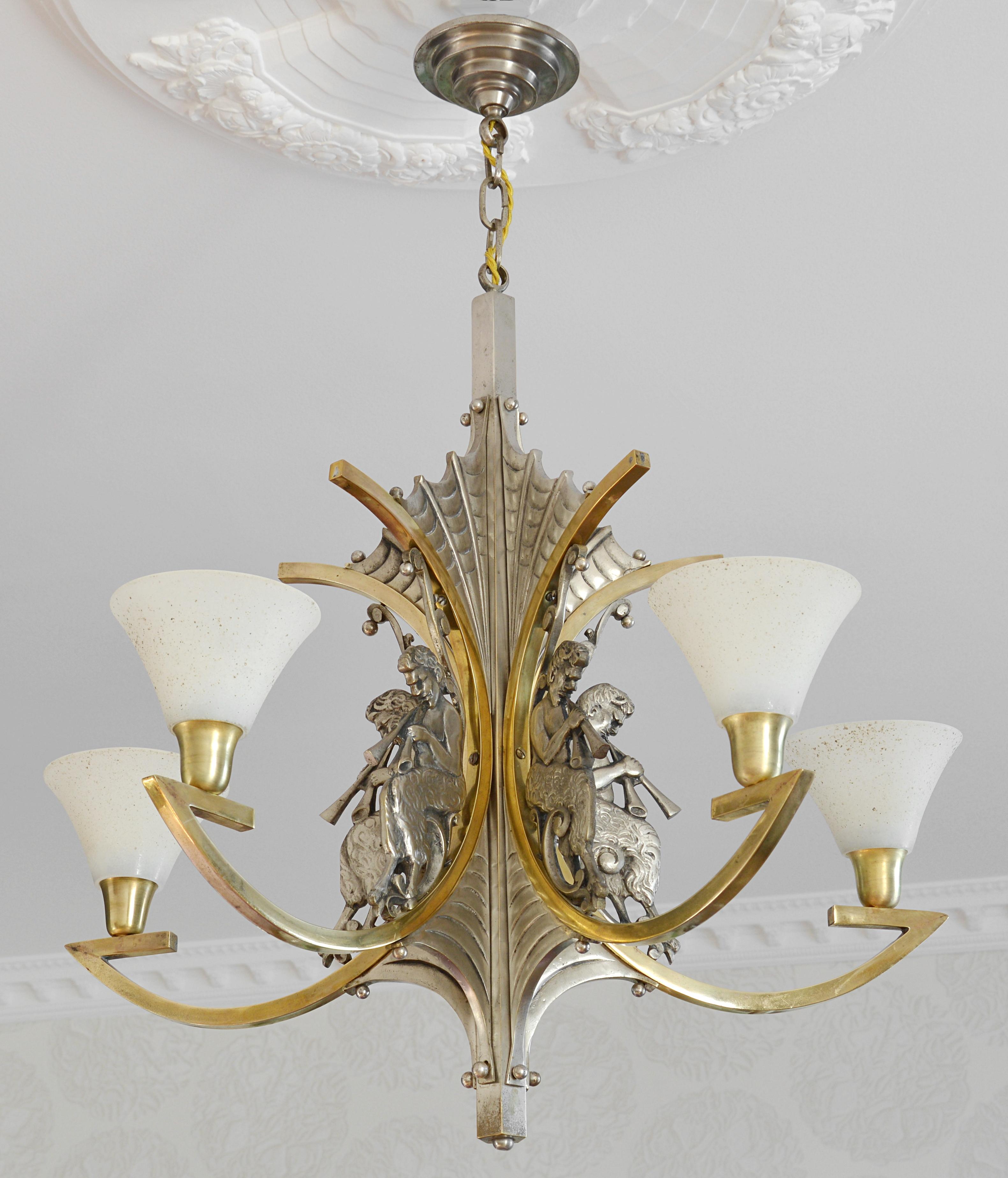 French Art Deco bronze chandelier, Paris, France, circa 1930. Gods pan. Solid silver plated bronze fixture showing five gods pan. Five granite-like glass shades. Very good condition. Traces of age on the metal fixture (see photos). Delivered wired