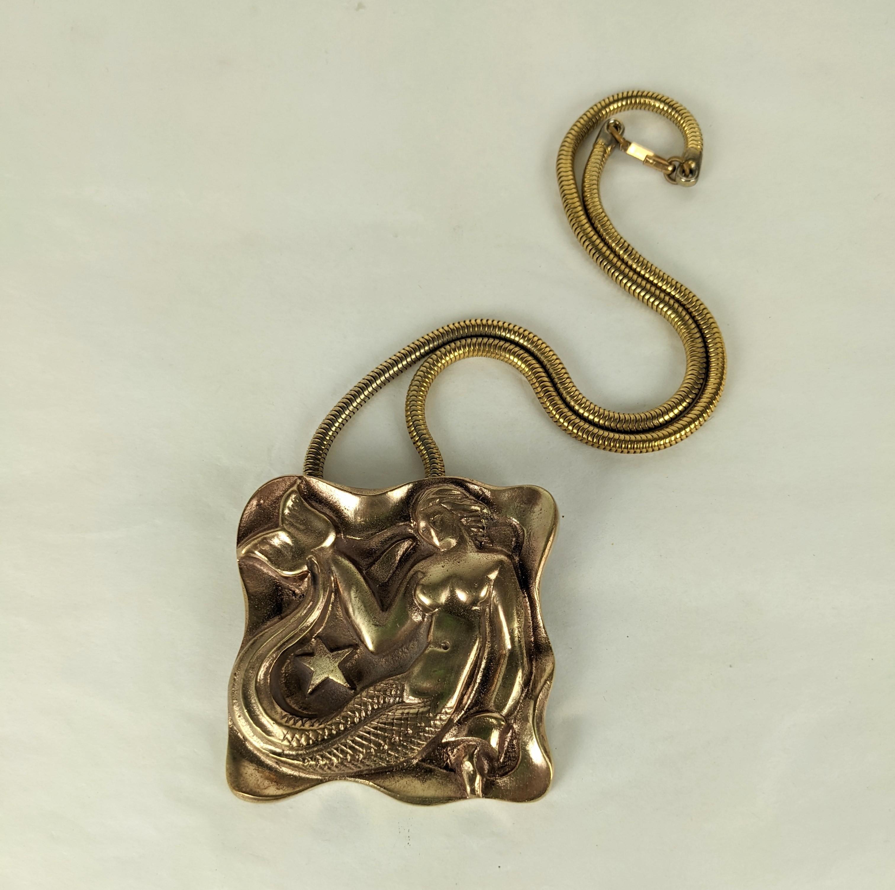 Unusual and striking French Art Deco Bronze Pendant converted from an antique furniture mount. An Art Deco mermaid is beautifully modeled around a star in this bronze pendant. A matching period Retro snake chain has been added to the pendant.