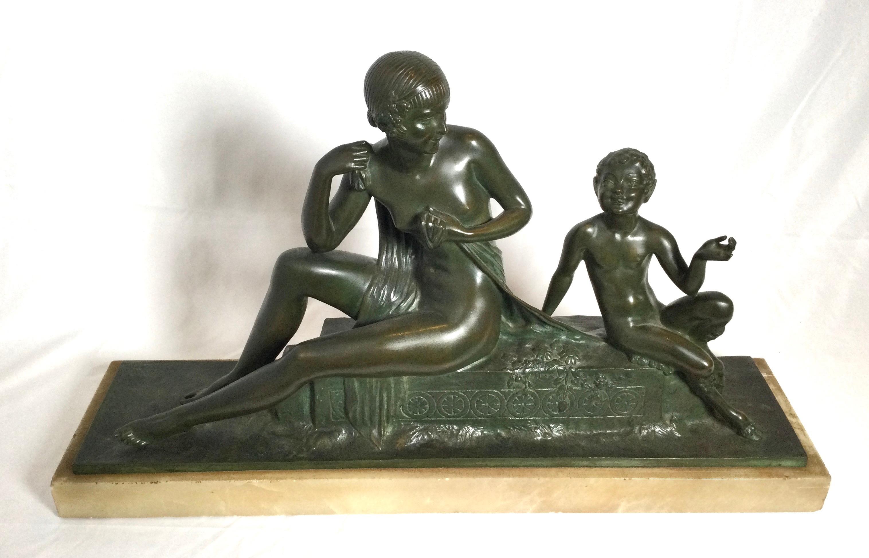 A beautiful patinated bronze of bacchante with pan by artist Joseph Descomp, France, 1920. The bronze in a green patination with an Art Deco style.