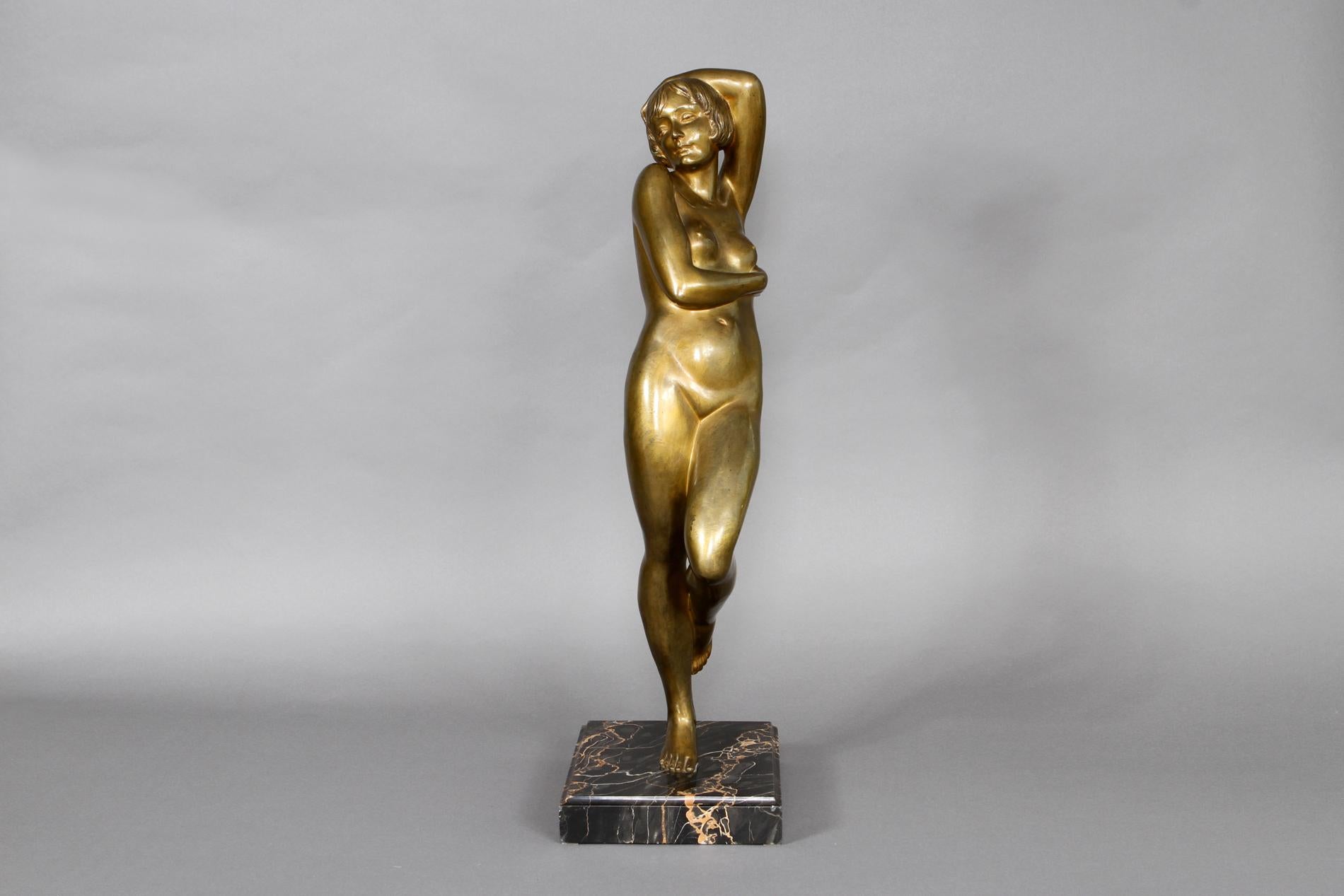 French Art deco bronze sculpture made by the french sculptor Marie-Louise Simard. The sculptor is all in gold bronze and has a base in portor marble. It represents a naked woman in a big format, typical style of the artist. 