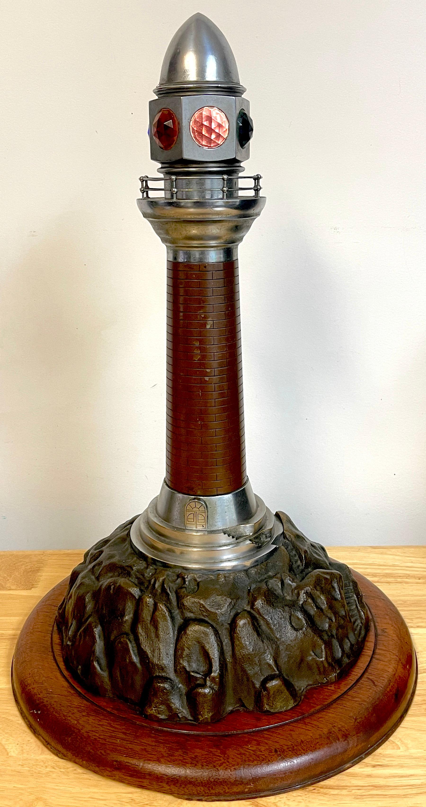 French Art Deco Bronze, Steel, Crystal and Wood Model of a Lighthouse Lamp, A substantial, intricately detailed model of a lighthouse, with inset colored cut crystal shades, on a 14