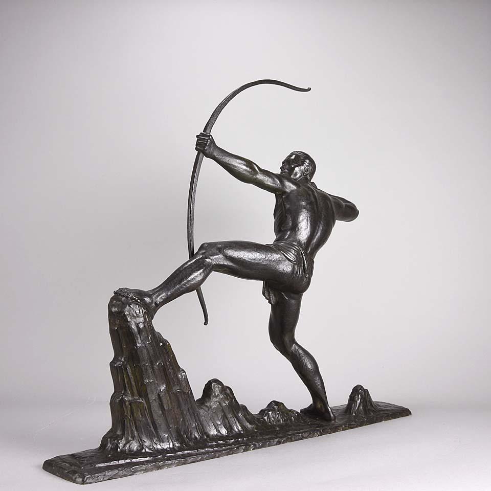 A powerful Art Deco bronze figure of an athletic man in a dramatic stance with his fore leg balanced upon a rock loosing his bow with excellent deep black and ochre coloured patina and very fine hand chased surface detail, signed Gibert

Lucien