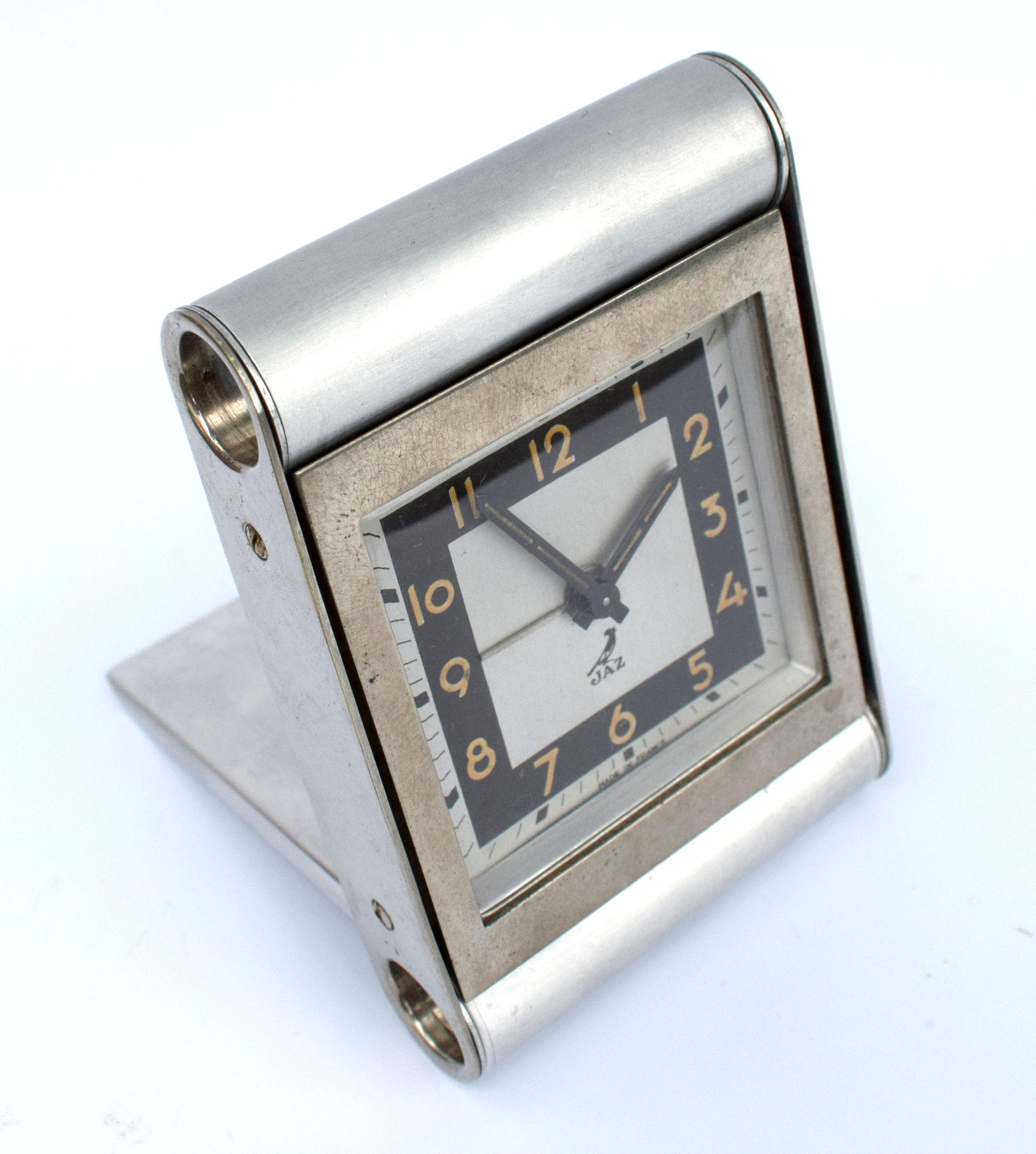 This is a super rare Art Deco travel alarm clock by JAZ a French clock maker. It's in perfect condition, quite literally we can't find any flaws to mention. Wonderfully stylish streamline design to the casing, which is brushed steel. We've tried to