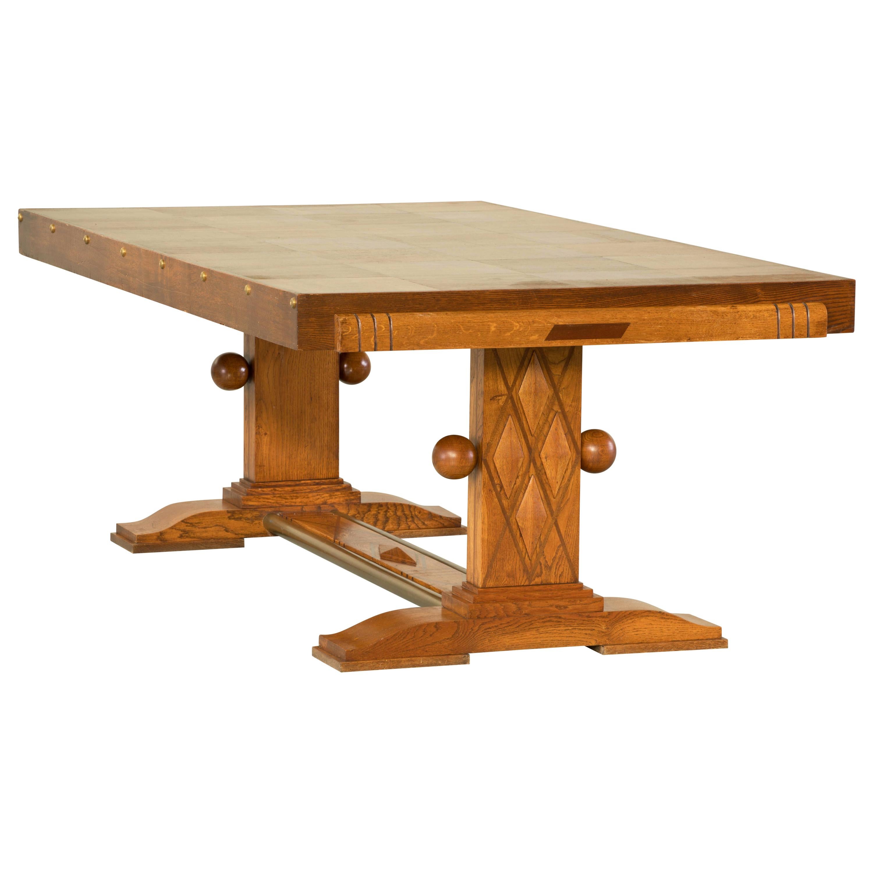 Dining table, oak, France, 1930s attributed to Gaston Poisson.

Majestic centre table in oak. This Art Deco table shows great craftsmanship. The base and legs are beautifully detailed with carving and woodwork. The rectangular top is plain, which