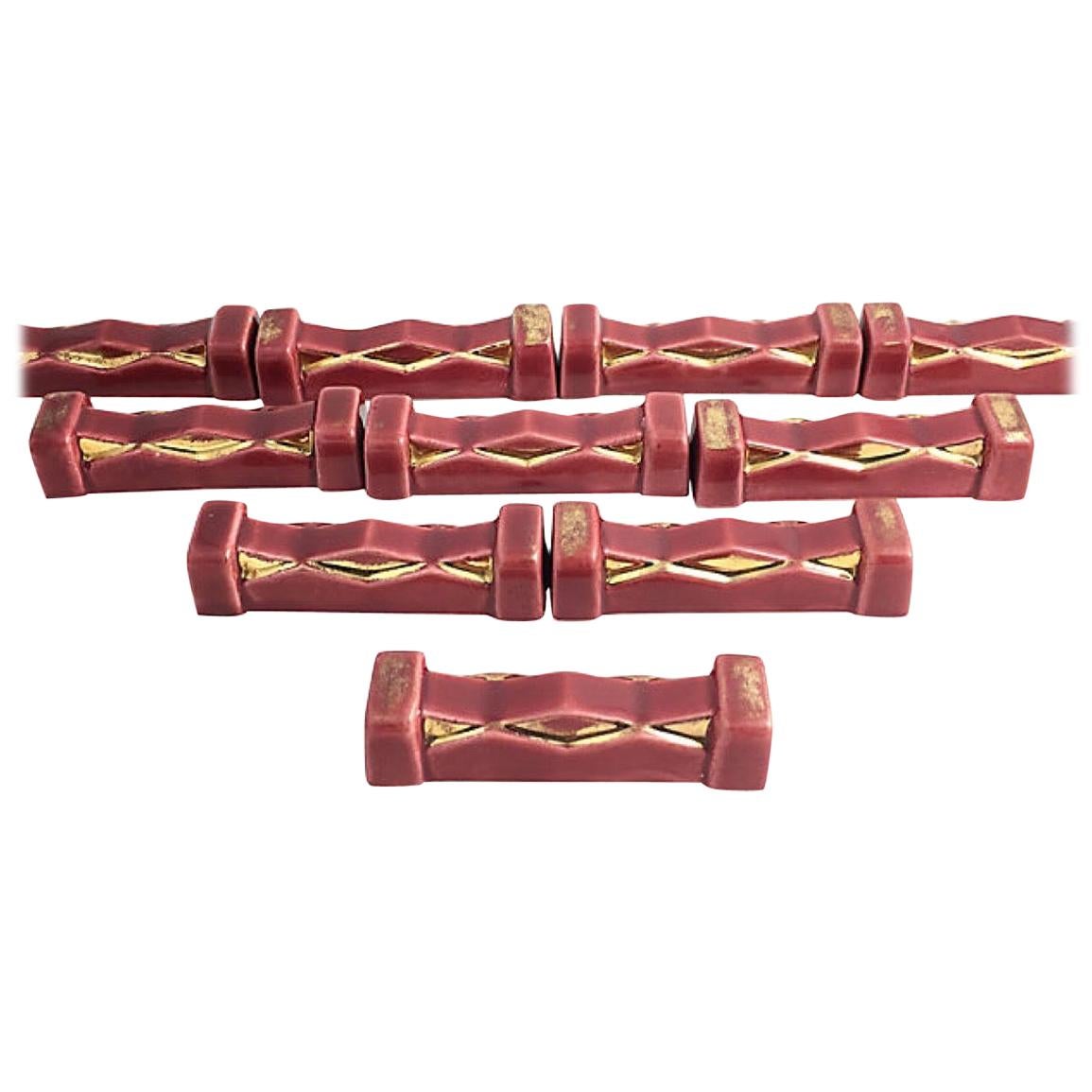 French Art Deco Burgundy and Gold Knife Rests, Set of 10 For Sale