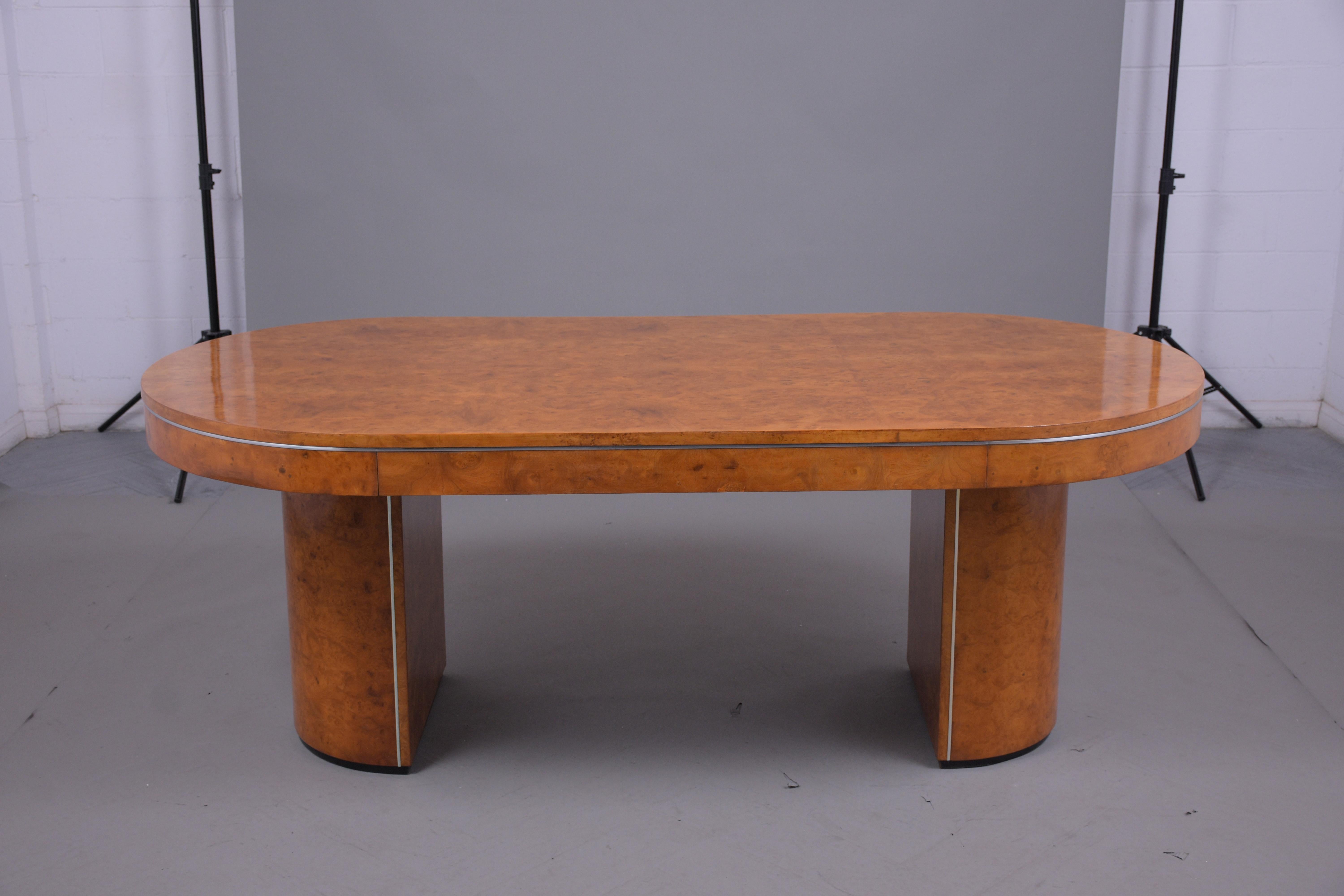 An elegant Art Deco dining table hand-crafted out of wood and exotic veneers, the table has been professionally restored and newly stained finish. This Mid-Century Modern executive table features a rich golden color with a remarkable lacquered