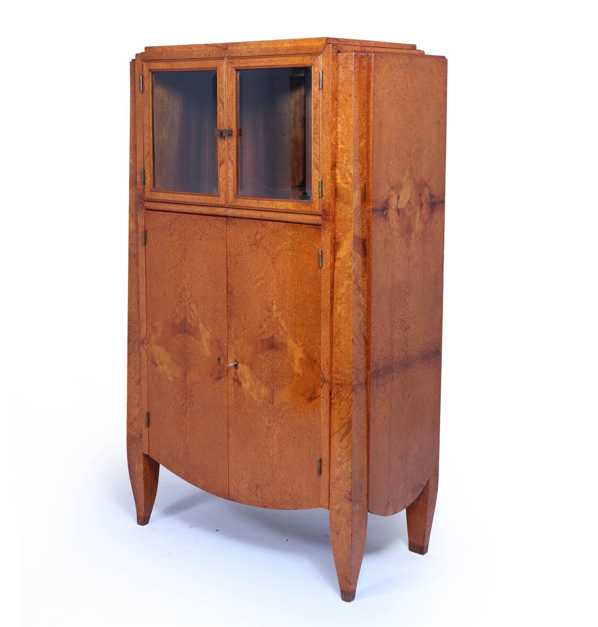 Art Deco Cabinet by André Arbus 

An exceptional quality cabinet produced by André Arbus in in France in the early  1930’s, it has two bevelled glass doors at the top and blind lockable doors to the lower section, absolutely stunning colour to the