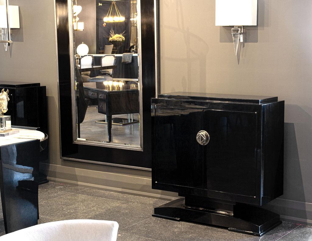 French Art Deco Cabinet in High Gloss Black. France, circa 1950’s, iconic Art Deco styling. Masterfully restored in a high gloss hand polished black lacquer finish. Cabinet offers great storage with 2 adjustable interior shelves. Complete your space