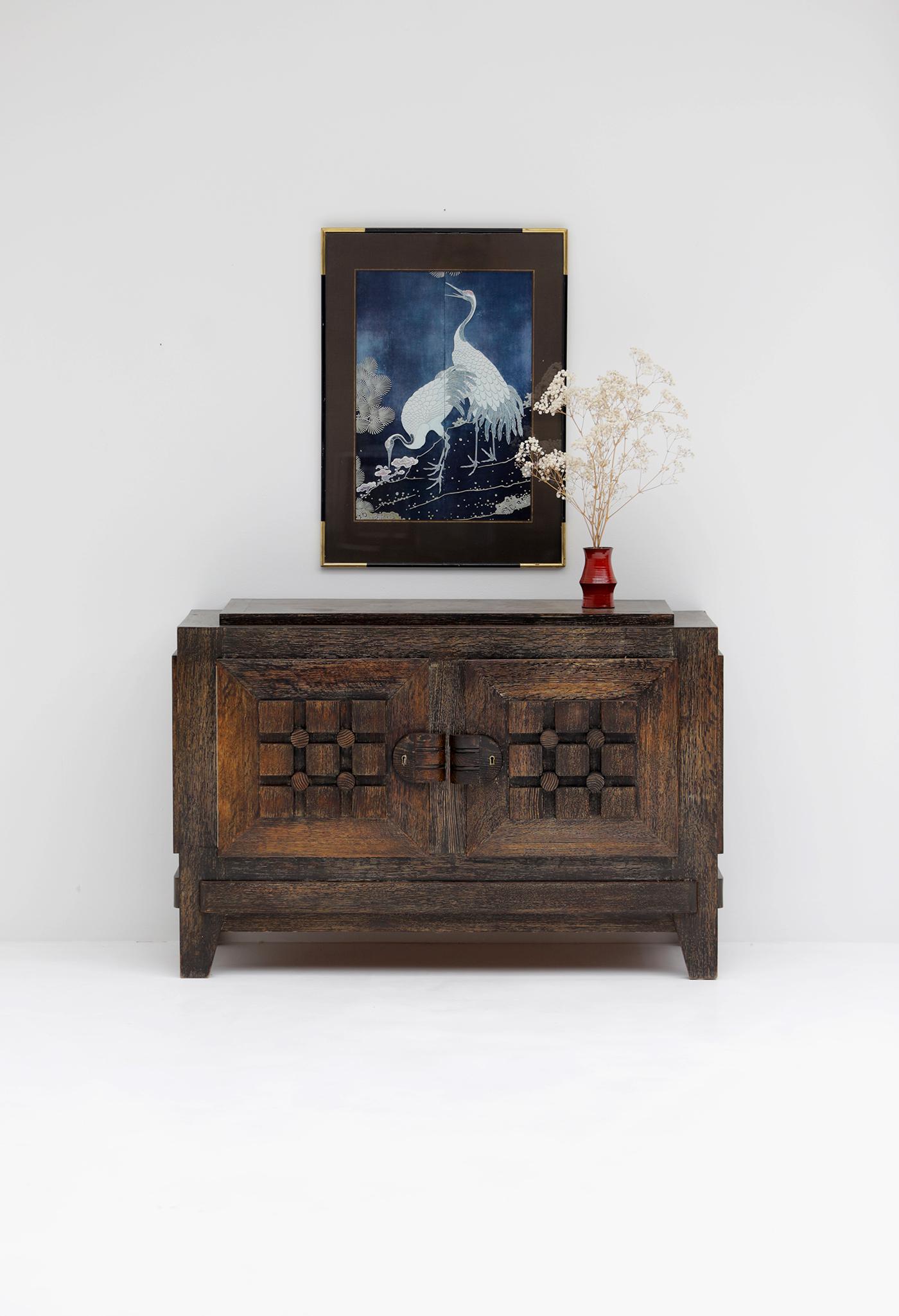 This handcrafted French Art Deco sideboard from the 1940s features elegant brass details and a timeless design. It has two storage compartments, hidden behind graphic detailed  door panels that give the piece a timeless look.
Although Art Deco and