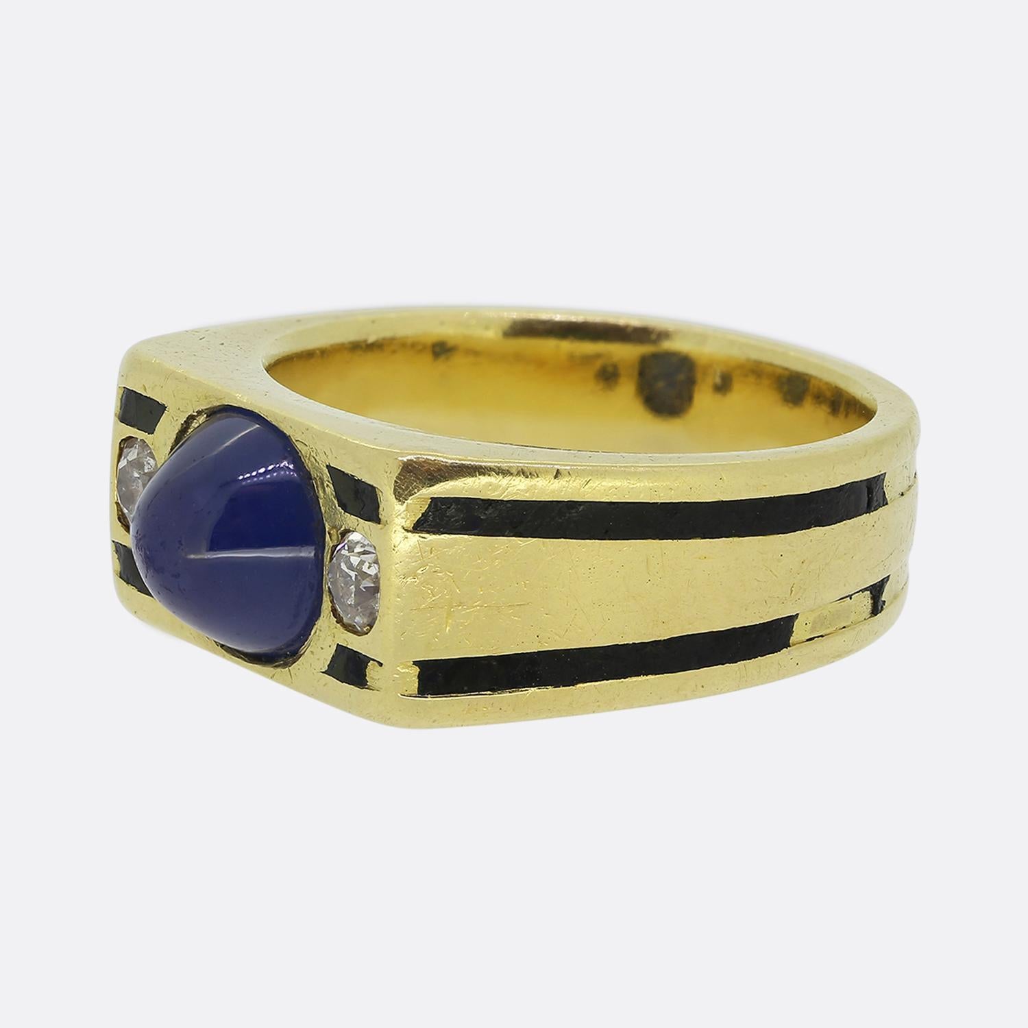 Here we have a striking three-stone statement ring crafted in France during the early stages of the 20th century. This warm 18ct yellow gold piece showcases a rectangular shaped face which plays host to a trio of precious gemstones. At the centre we
