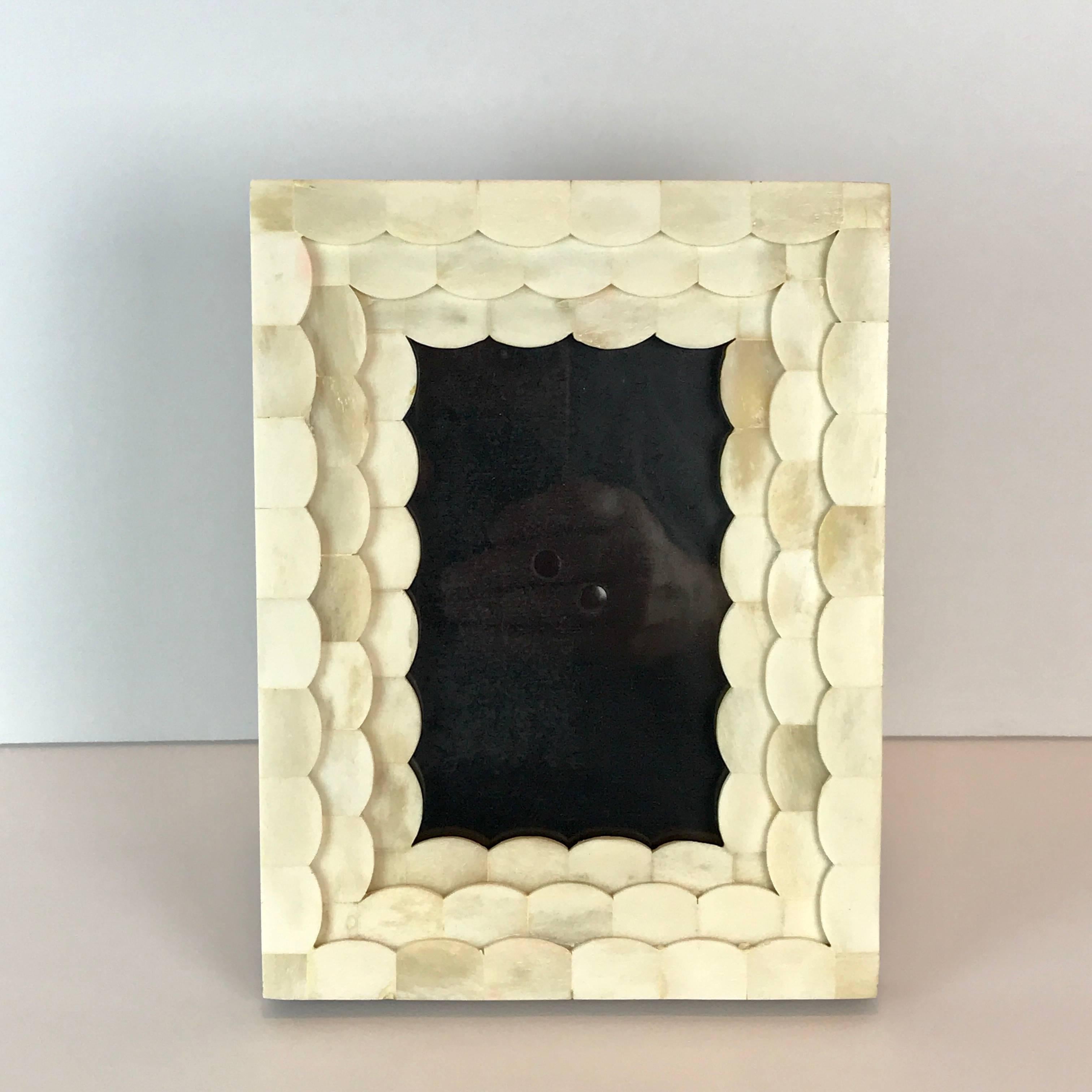 French Art Deco carved bone frame with wood back. Shows a 3