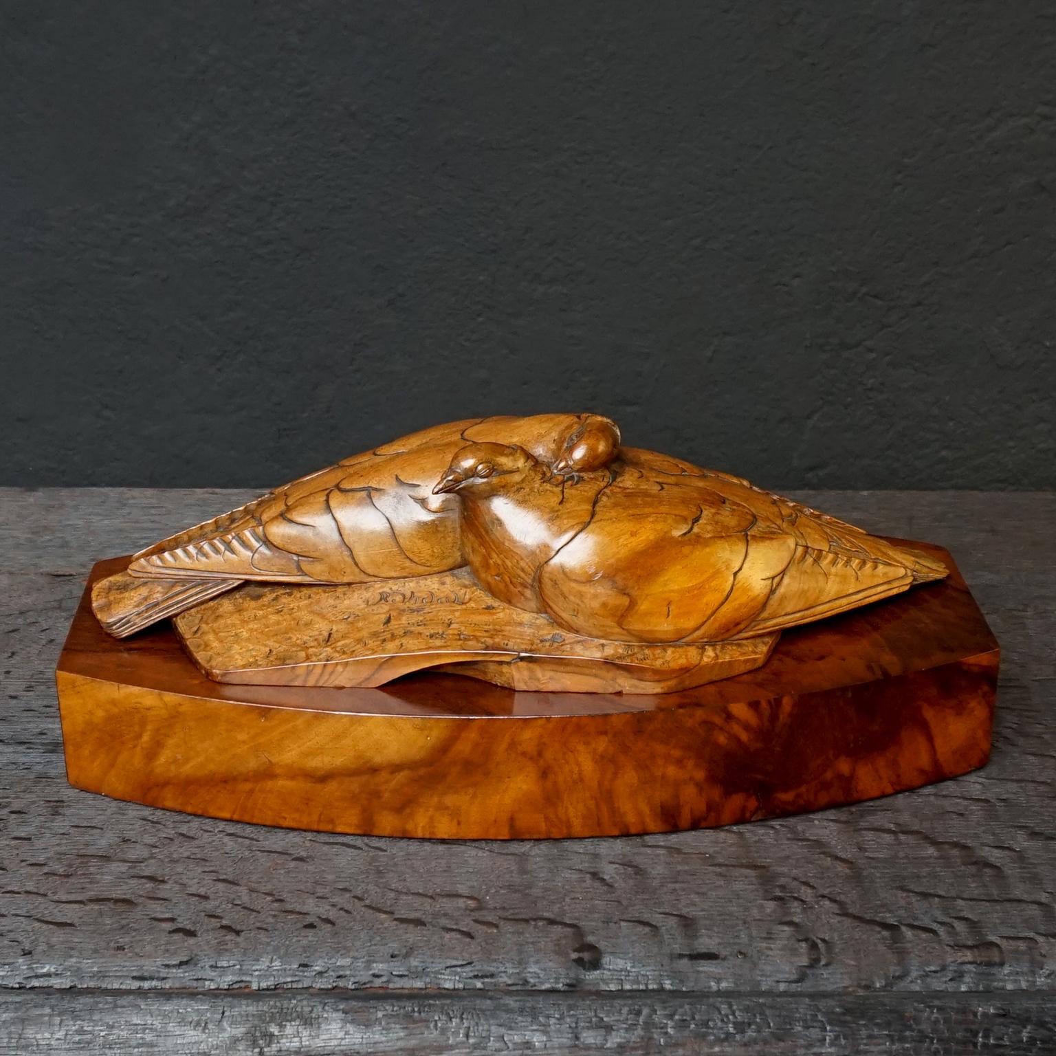 Very pretty Art Deco love letter box in carved walnut wood, would also be great to keep jewellery in.
Two detailed carved doves lying in an amorous embrace pose on a wooden base in which a love letter compartment is 'hiding'.

The 'box' part is