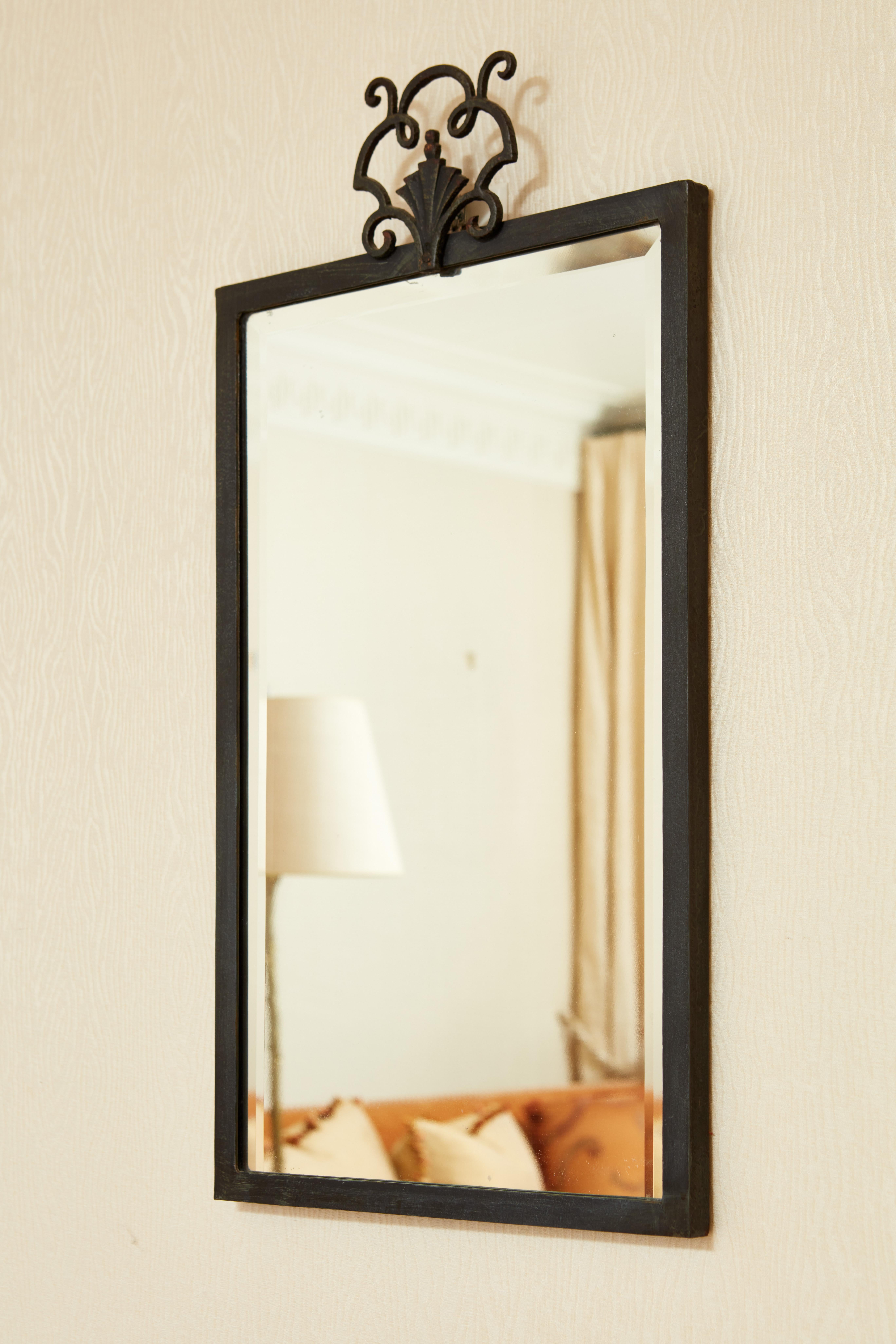 Lovely French cast and wrought iron mirror with a small decorative detail on the top. 
