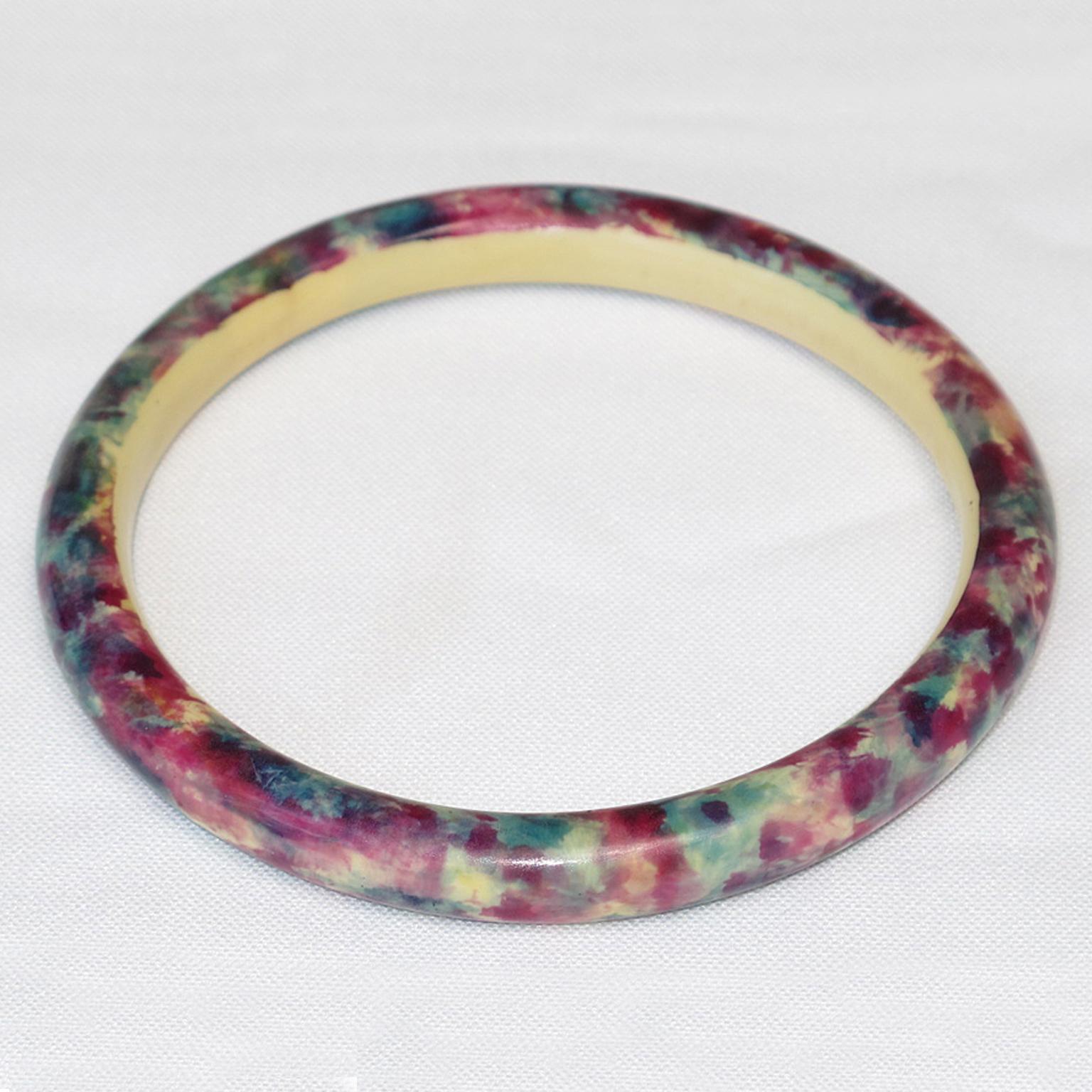 A striking 1920s French Art Deco celluloid bracelet bangle. It features a light hollow tube shape with a sponge paint application design around the bracelet. 
The hollow bracelet technique is an ancient technique applied to jewelry at the turn of