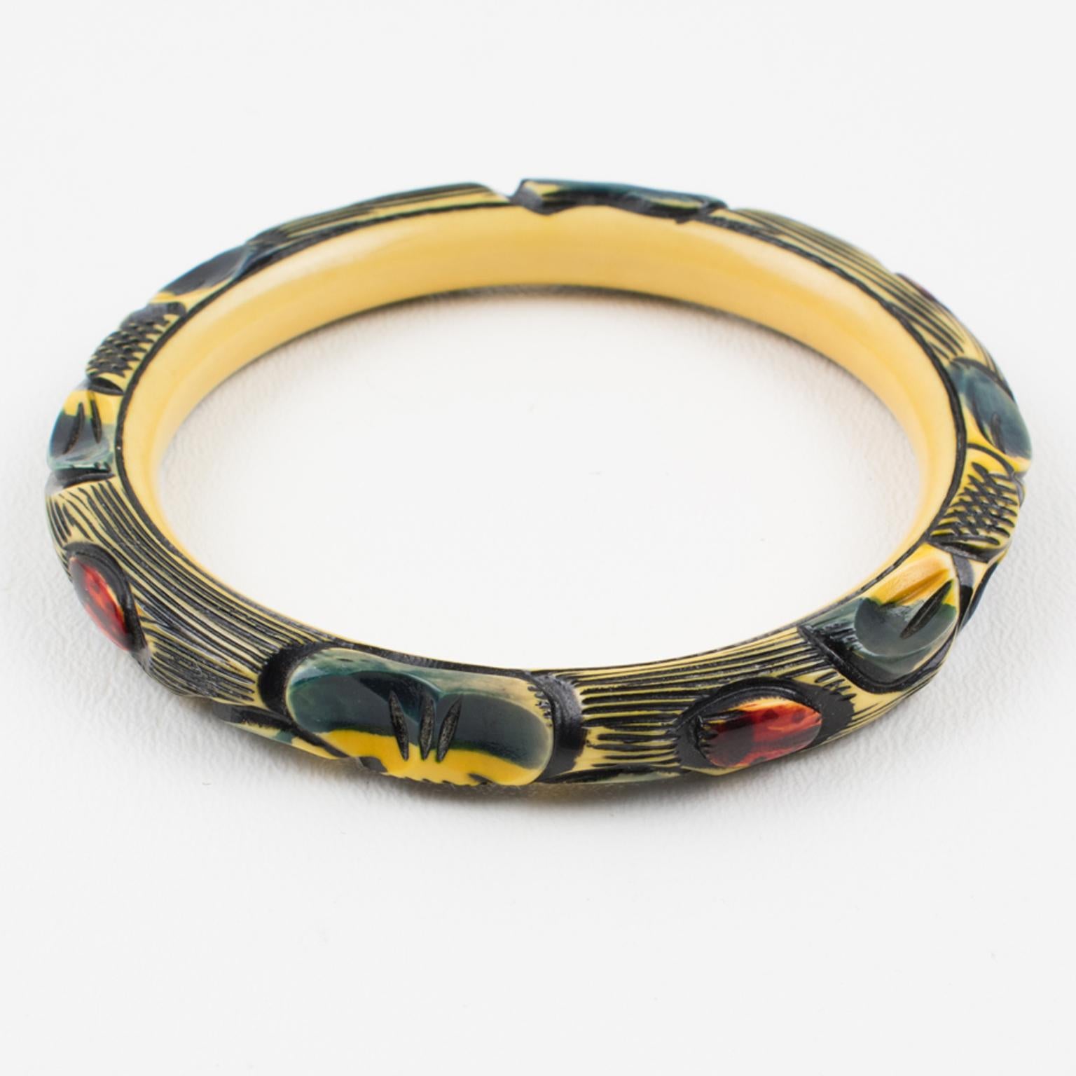 Beautiful 1925s Art Deco celluloid bracelet bangle. Features floral and ladybugs design, four motifs of each all around the bracelet deeply carved, painted, and stained. A lovely range of assorted colors with off-white, black, navy blue, yellow, and