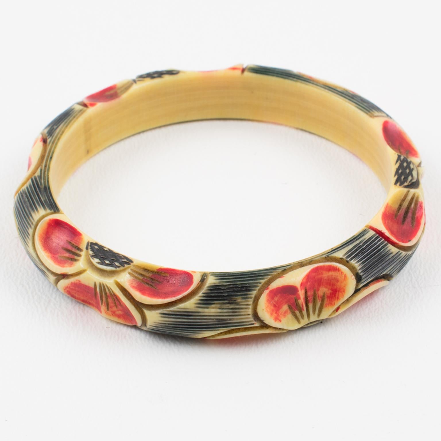 Elegant 1925s Art Deco celluloid bracelet bangle. Features floral design, with six motifs all around the bracelet deeply carved, painted, and stained. A lovely range of assorted colors with off-white, black, and red.
Measurements: Inside across is