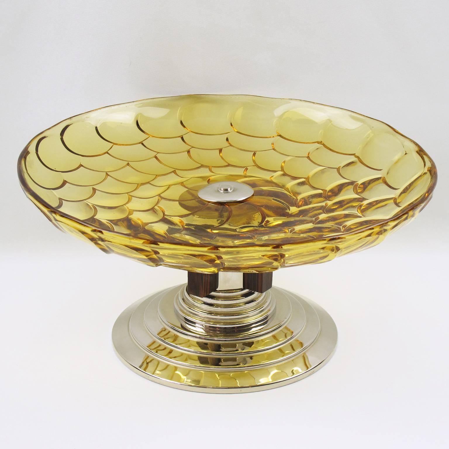 Very stylish French Art Deco modernist centerpiece or bowl. Large round glass bowl with tortoiseshell molded pattern in lovely bright yellow marigold color. Pedestal base in chromed metal and Macassar wood with unique asymmetric skyscraper pattern.