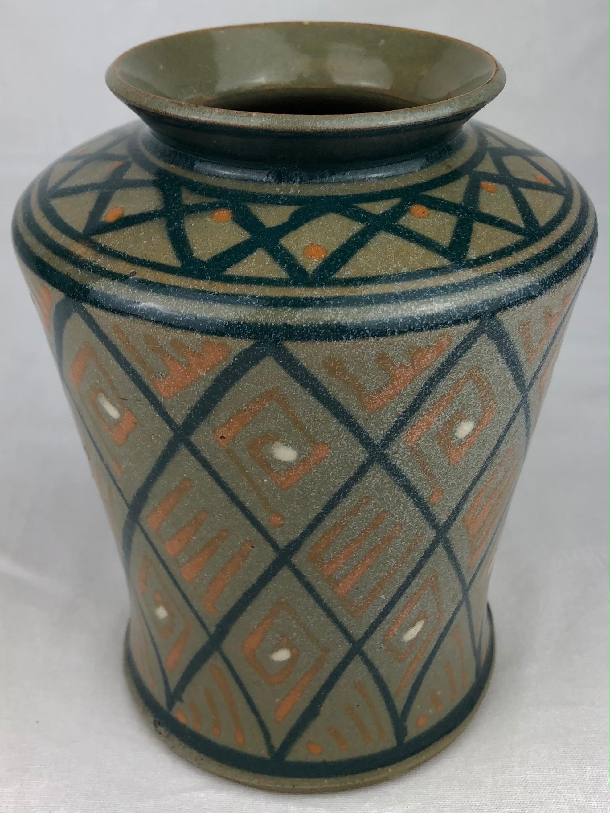 This dazzling glazed French Art Deco ceramic vase or small planter was handcrafted. The mixture of colors are truly beautiful. 

It can enhance any shelf, table, credenza or countertop as it is truly an interesting decorative object.

Measures: