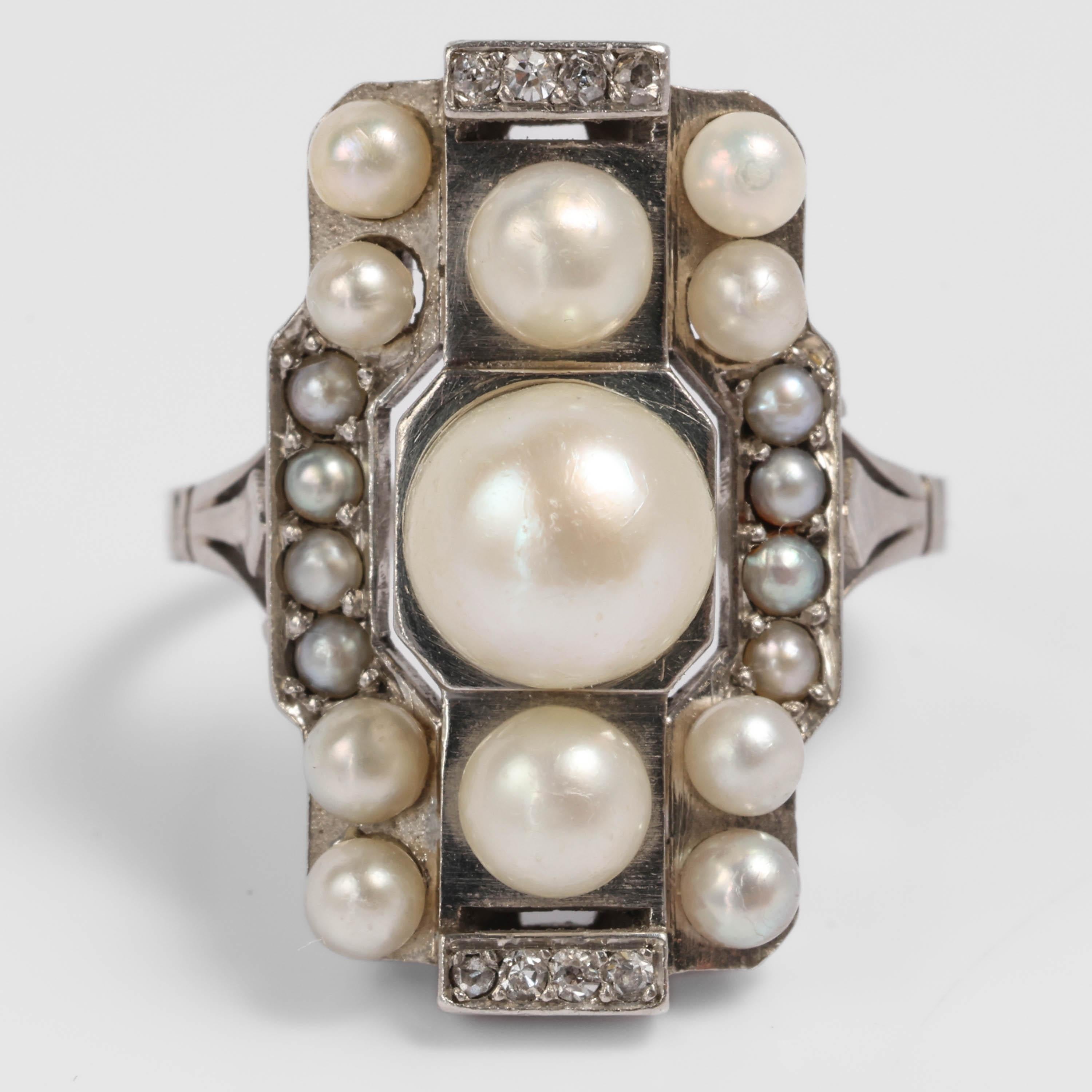 A French Art Deco masterpiece! Created in France in the 1920s, this natural saltwater pearl and diamond ring is a geometric tour de force and one of the most gorgeous natural pearl rings in my collection. 

The gleaming platinum mounting was