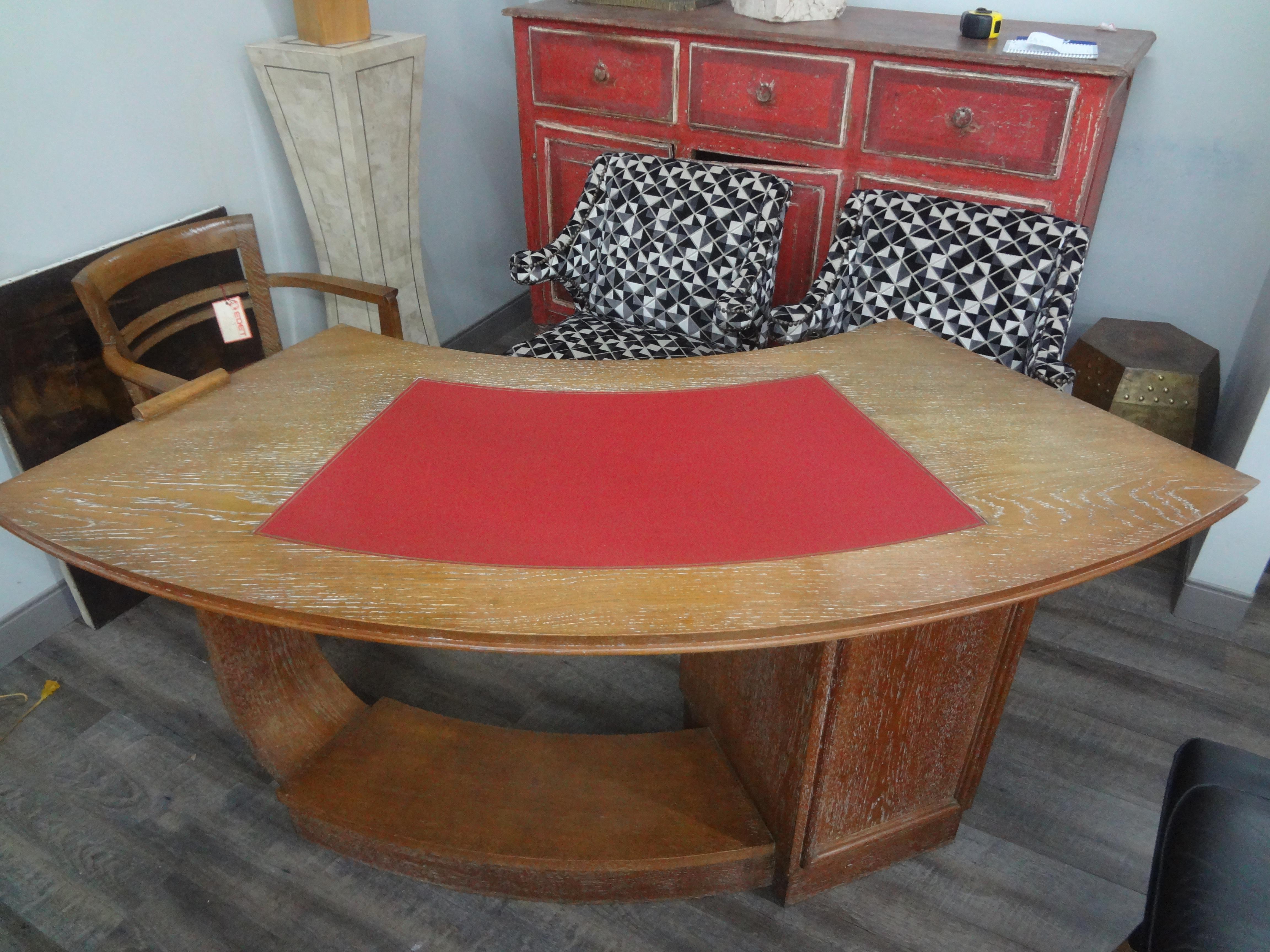 French Art Deco Cerused Oak Desk Attributed To Andre Sornay.
Handsome French Art Deco cerused or limed oak desk or writing table with four drawers and a red leather top attributed to Andre Sornay. This stunning curved desk has beautiful lines on