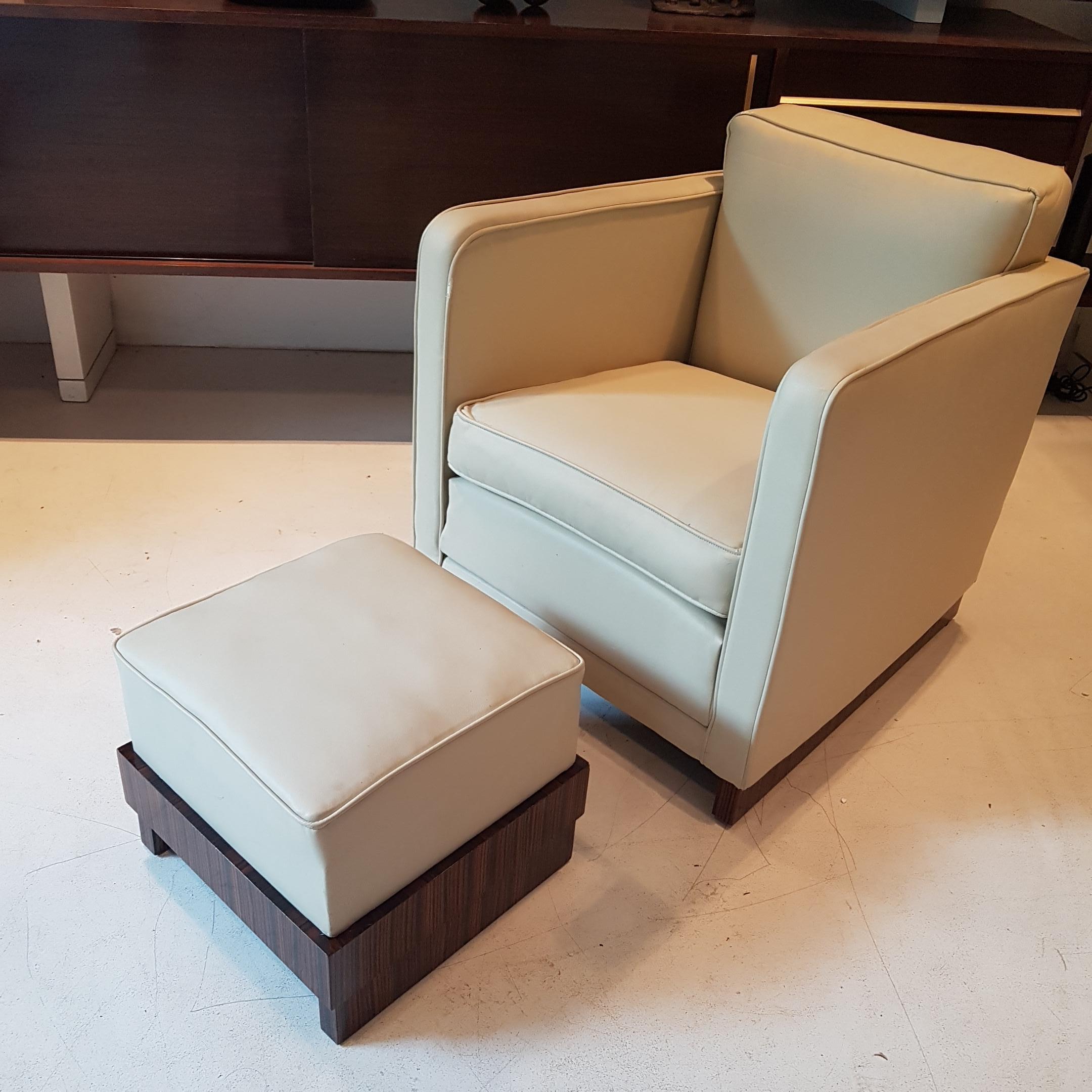 Well sized, comfortable Art Deco club chair in a classic Art Deco square shape with matching footstool. This comfortable armchair has a beautiful macassar ebony base as has the matching footstool.  Rather than having legs the chairs have a