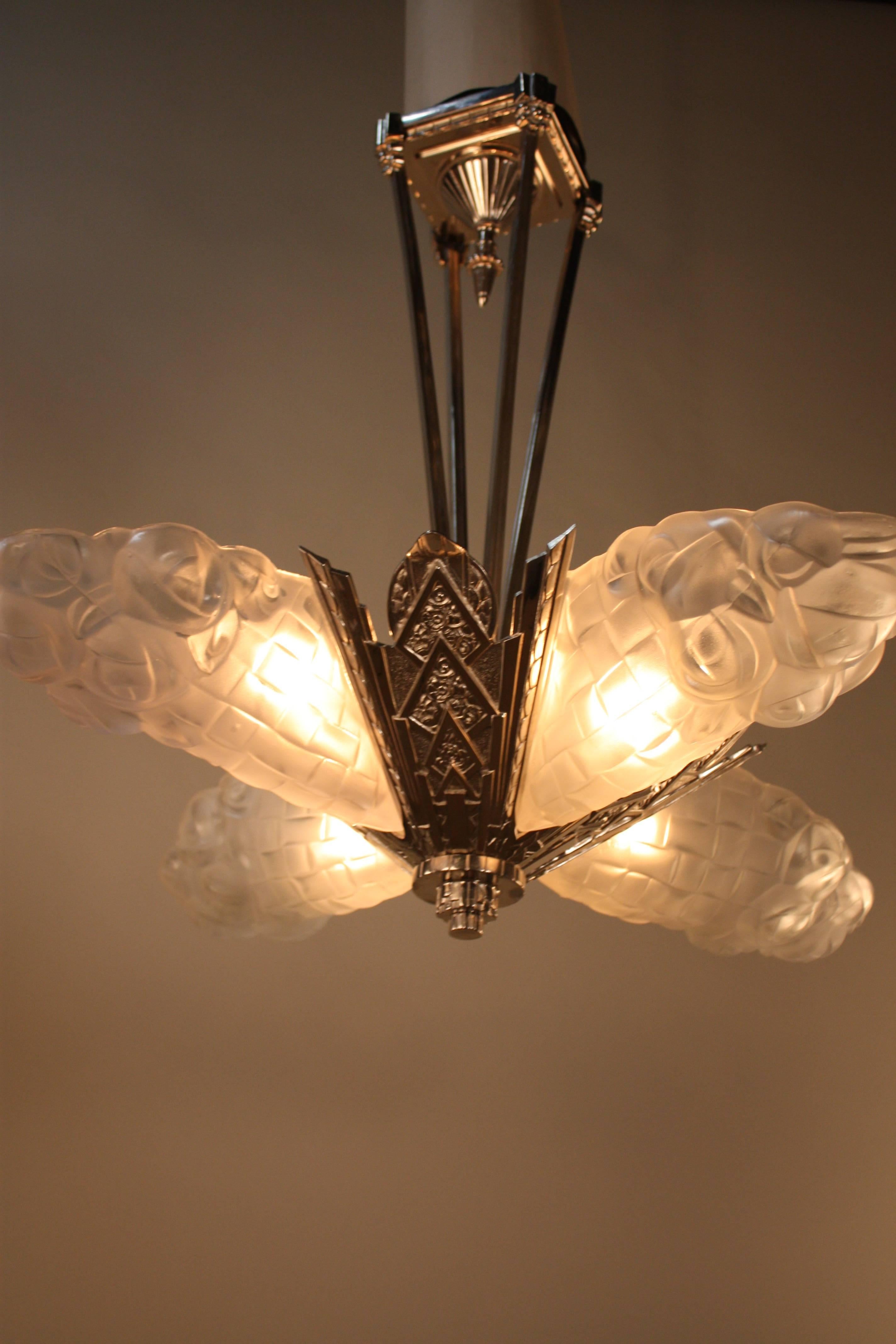 A stunning Art Deco chandelier. Crafted in France, this chandelier features four glass panels with beautiful detail work. The hardware is fantastic nickel on bronze. The chandelier measures 28