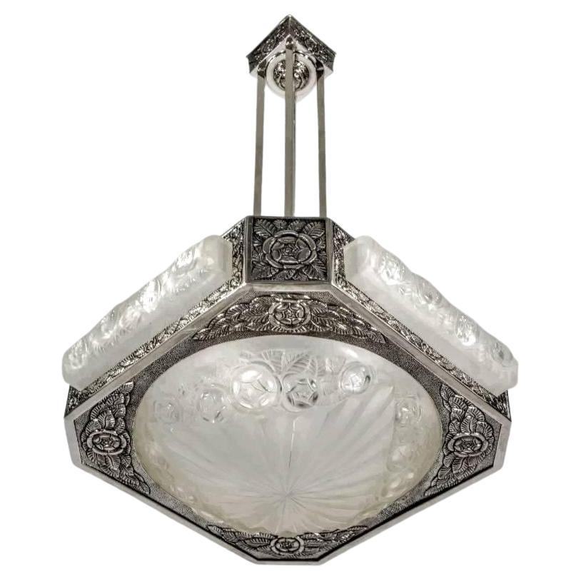 Stunning French Art Deco chandelier was created by the French artist Degue in the 1930s. In a square nickel bronze frame embrace a center shade marked Degue, with four matching oblong shades marked with the numbers “501”. All shades are in clear