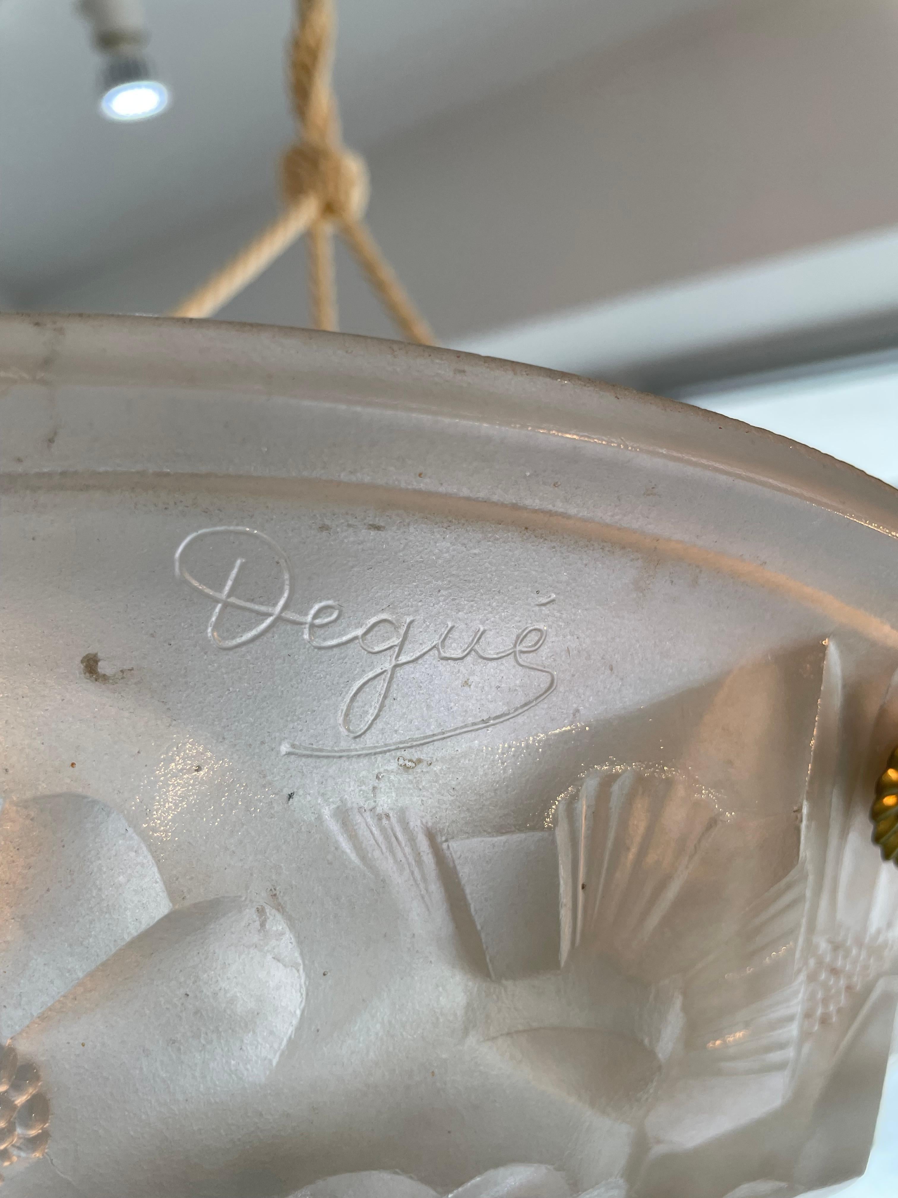 This stylish and chic Art Deco chandelier was designed by and it dates to the 1920s-1930s. 

The piece is marked with the pattern number of 554, France and Degue.

Note: Retains its original European canopy and wiring. 

Note: Requires one Edison