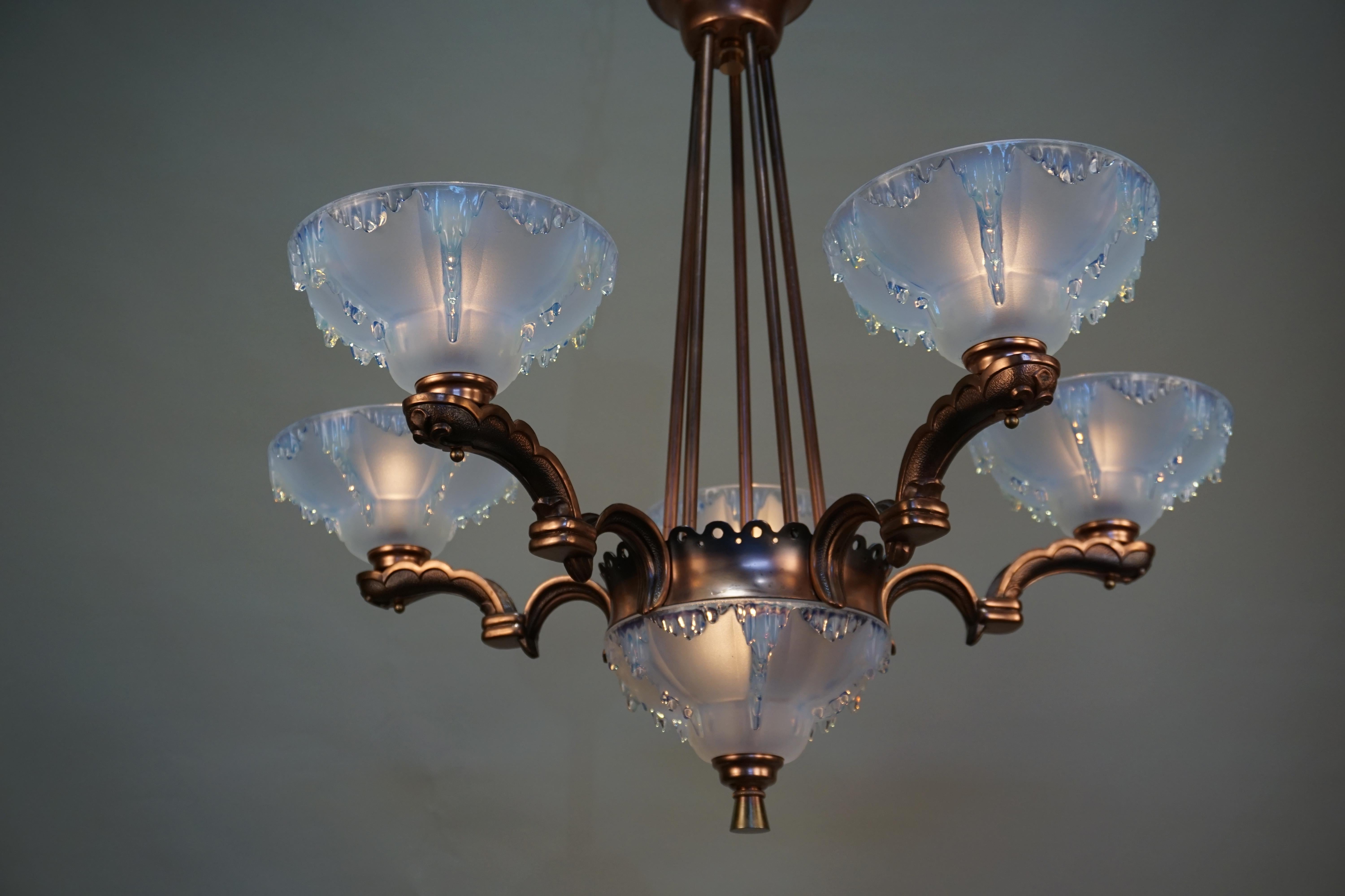 French six-light Art Deco chandelier with opalescent glass shades and copper finish frame.
Six lights 60 watt each.