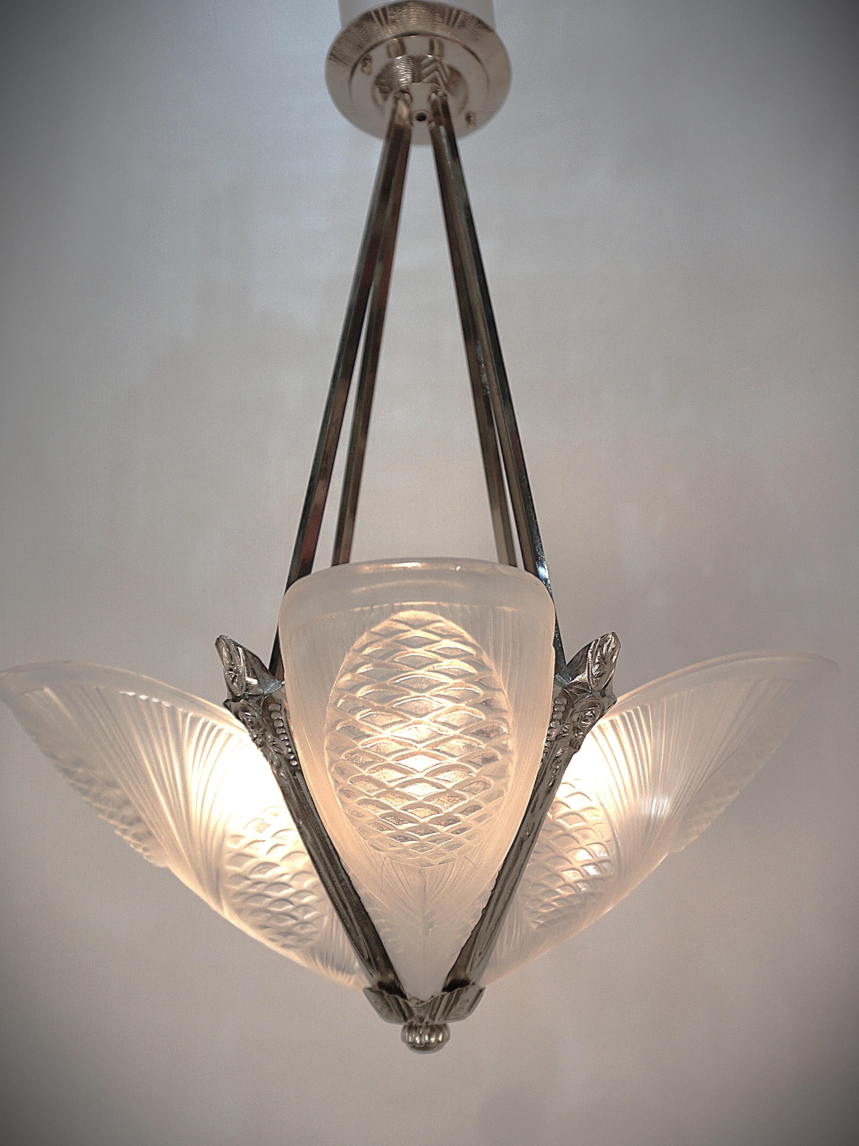 Clear frost glass in pine crone design and nickel on bronze frame French Art Deco chandelier by Jean Noverdy.
Professionally rewired and ready for installation. 
Measurement: 20width (widest point) 24