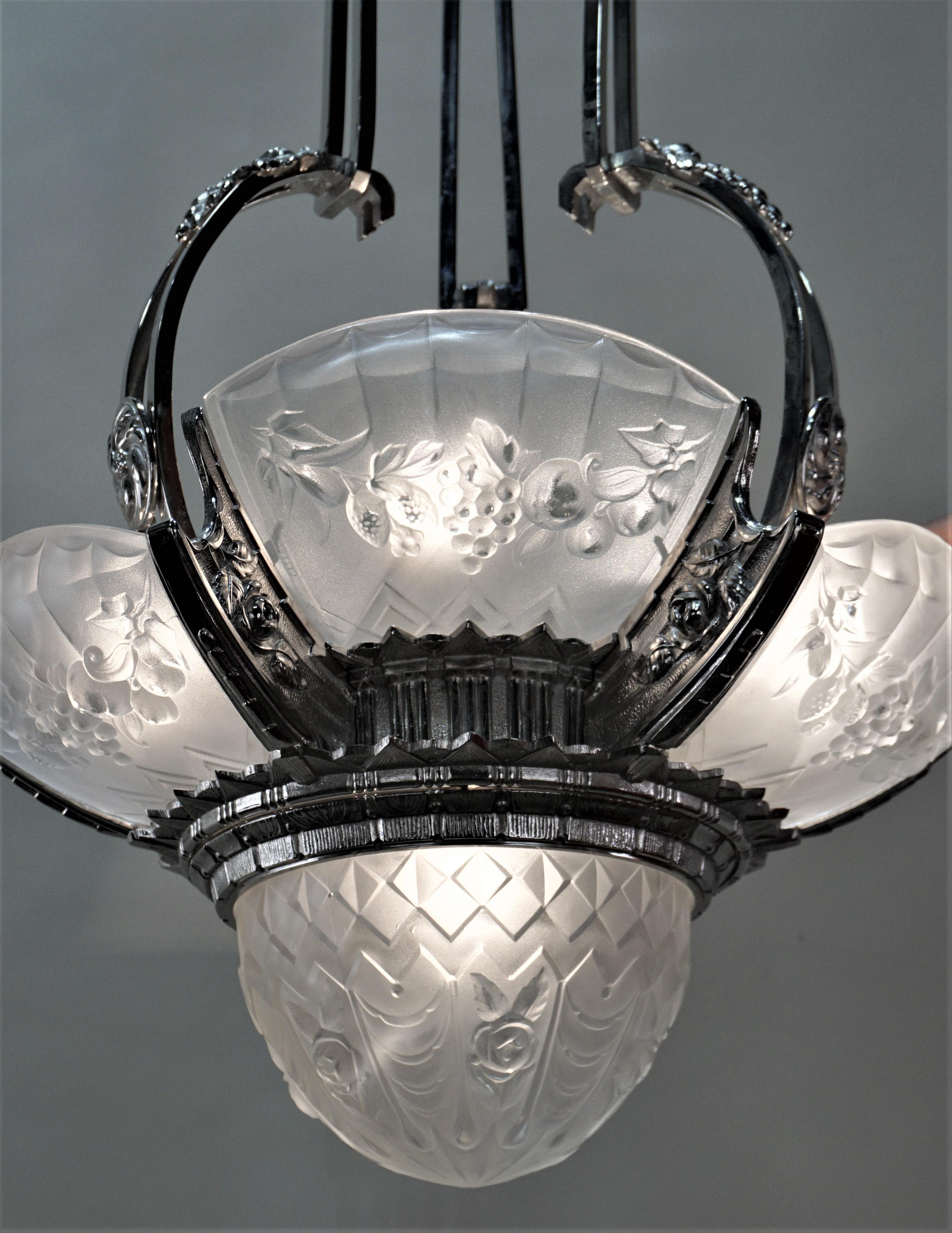 A rare design French Art Deco nickel on bronze chandelier with height light polished clear Frost glass.