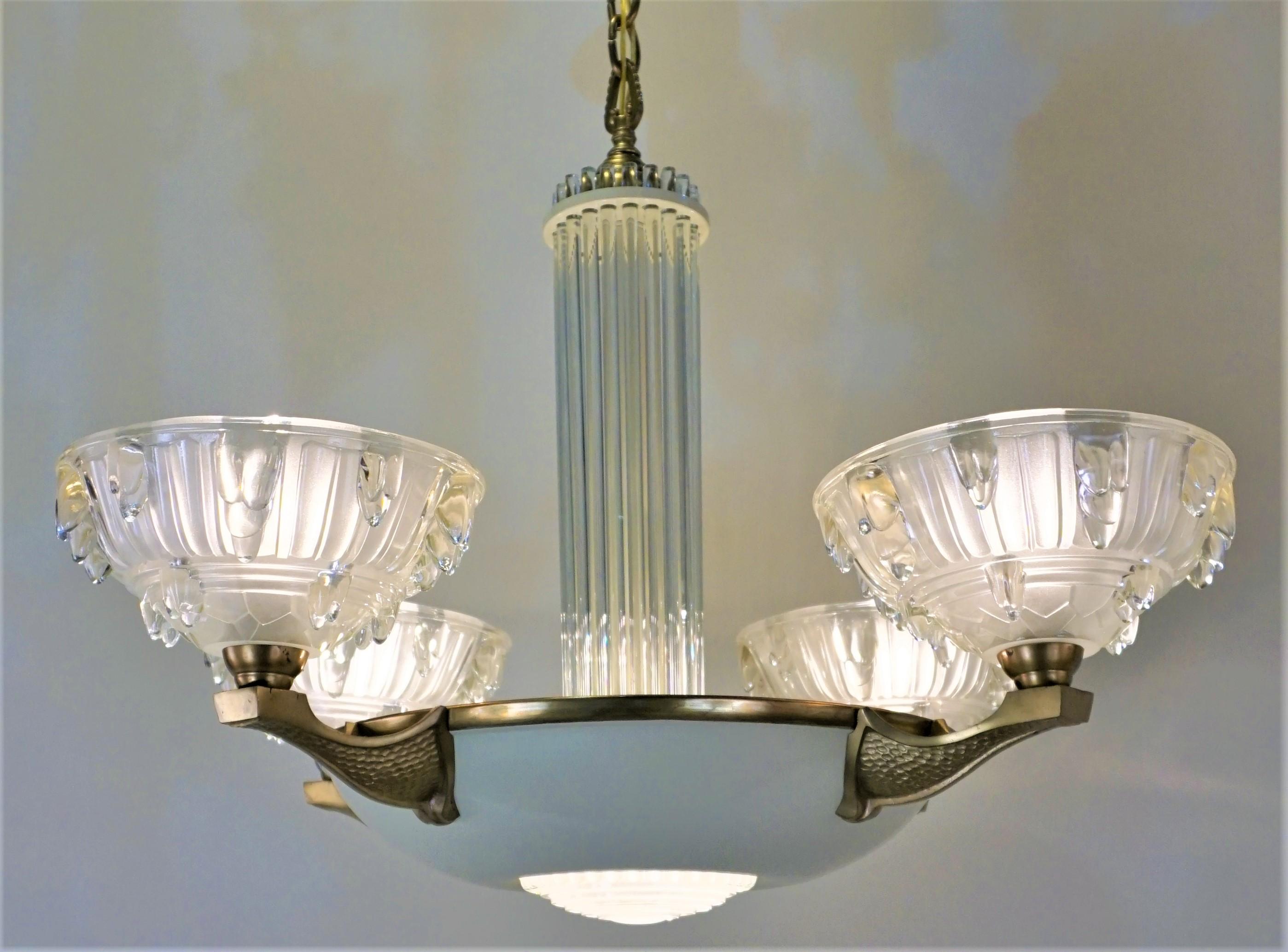 French Art Deco eight bronze chandelier with glass rod and molded glass shades.
The total height of this chandelier with all the chain is 43