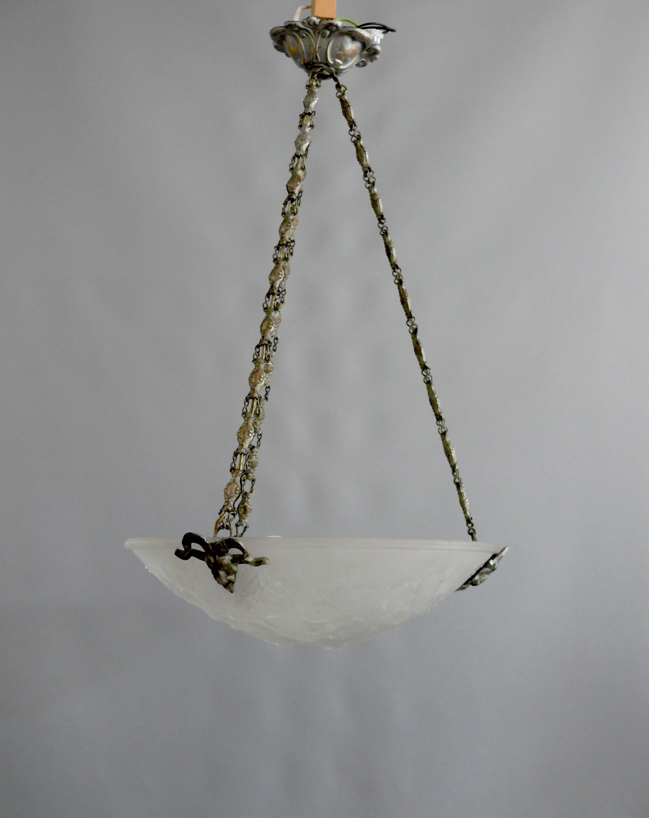 French pendant lamp from the 1920s-1940s with an opal glass shade and chain suspension by Muller Frères Lunéville in good original condition. The ornate glass shade has a beautiful surface with a geometric structure. The suspension is made of brass