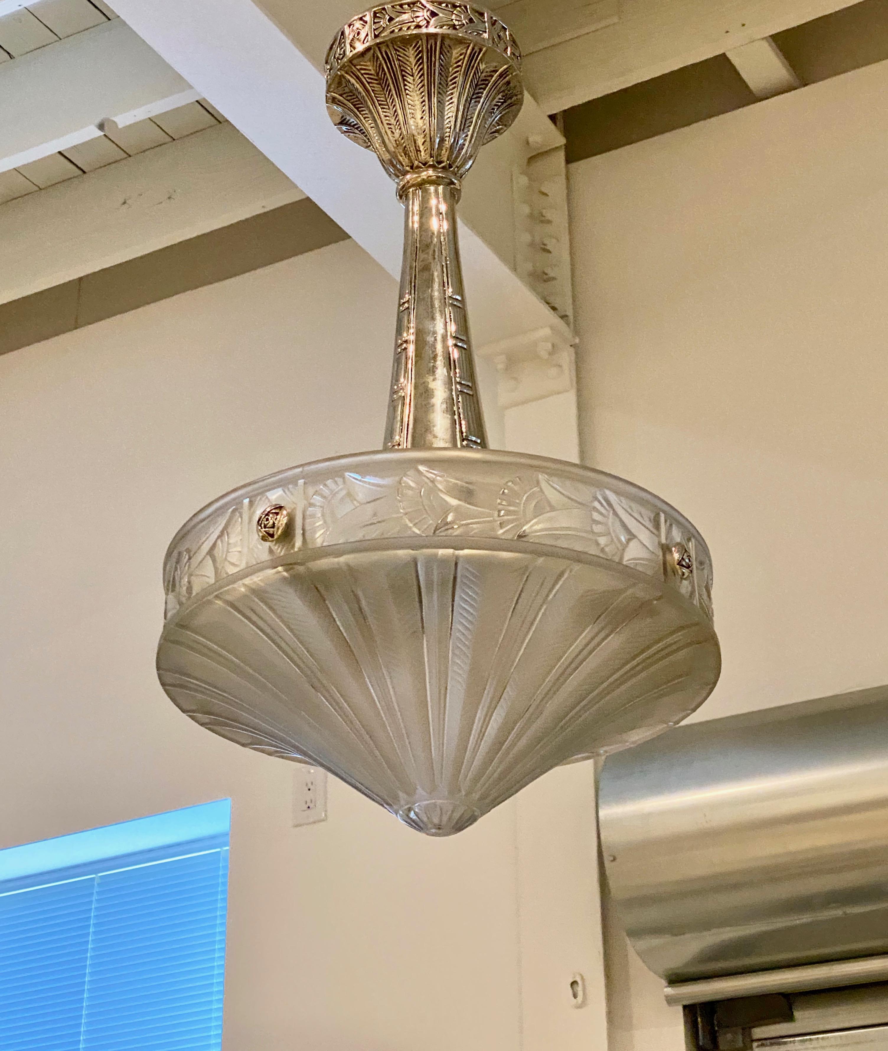 French Art Deco chandelier signed by Lorrain Nancy France. Clear frosted glass shade with floral and geometric motif held by nickel (silver) design frame. The frame having beautiful Deco details through out. Has been rewired for American use with
