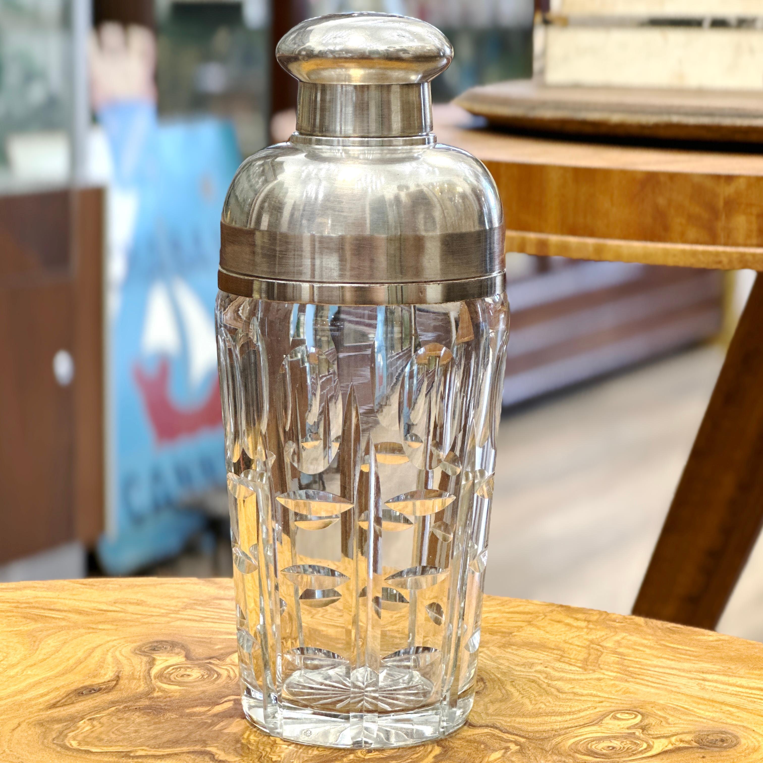 Here is a fabulous French Art Deco Style Chrome and Crystal Martini Shaker. This piece features a heavy cut crystal cup with a beautiful geometric design. Fastened to a three piece chrome shaker top. Shaker is in excellent ready to use pre-owned