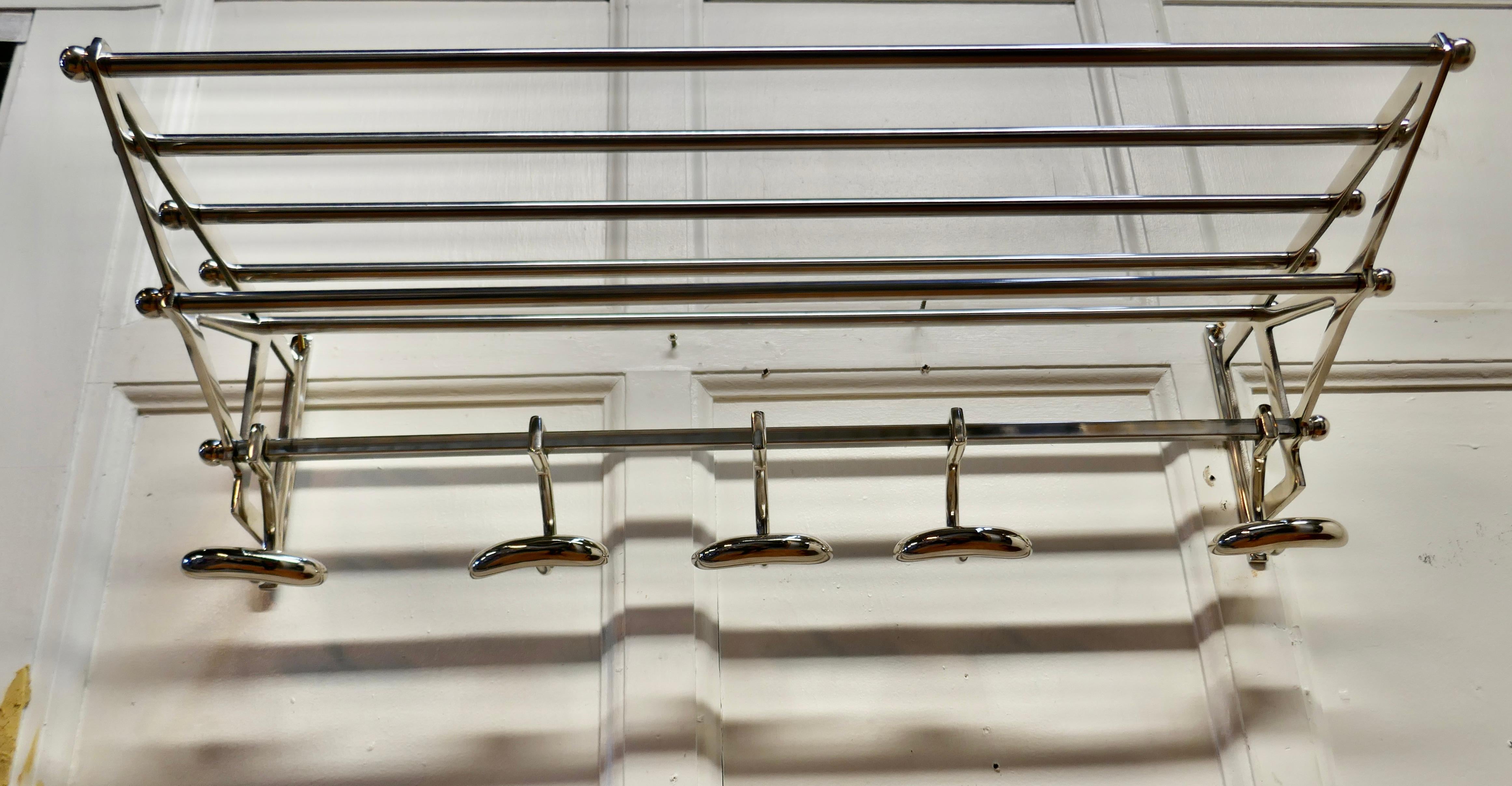 French Art Deco chrome hat and coat rack, railway train style

 This Art Deco style hat and coat rack has five sliding hooks and an upper railed shelf 
Racks just like these were used on French railway trains like the ones on “the Orient