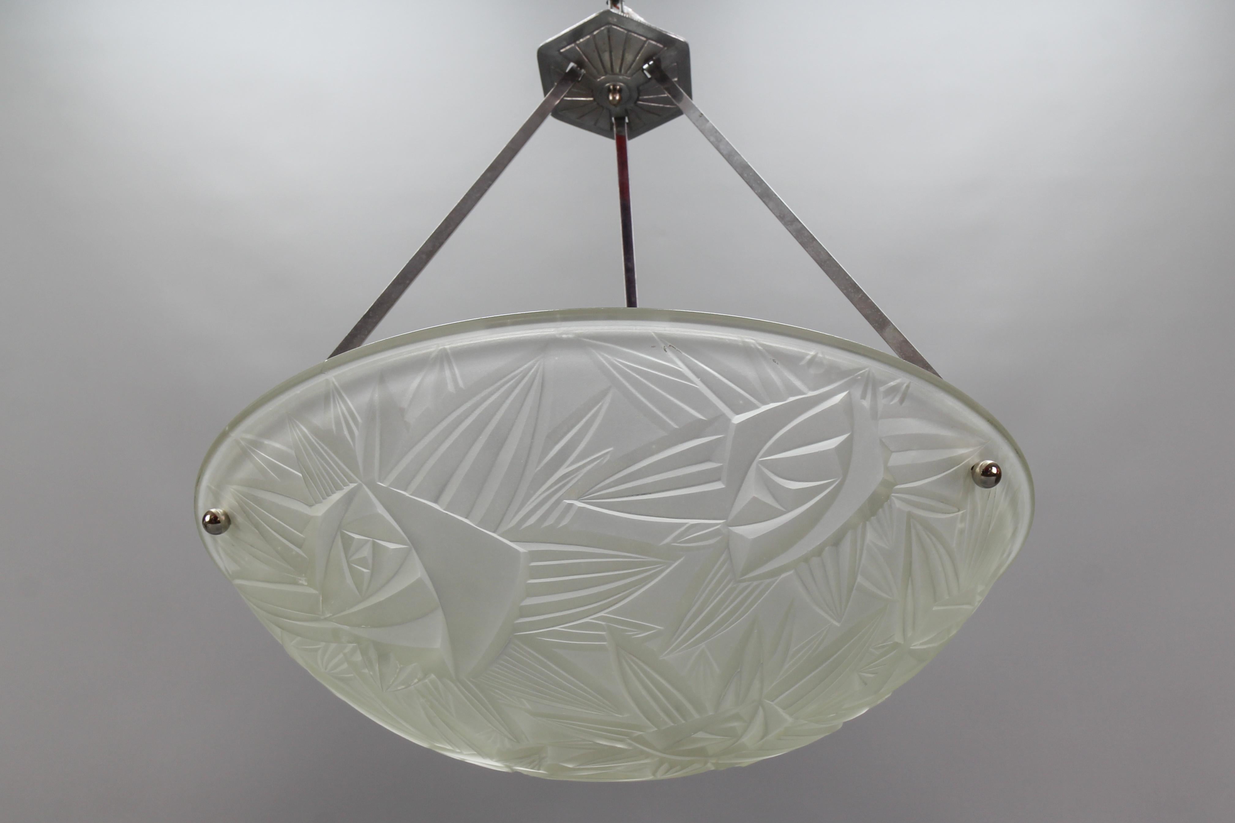 French Art Deco pendant light with frosted white glass lamp shade/bowl by Jean Noverdy, circa the 1930s.
This beautifully shaped white frosted glass bowl features stylized flower and leaf decoration, marked on the edge ”Noverdy France Depose” and