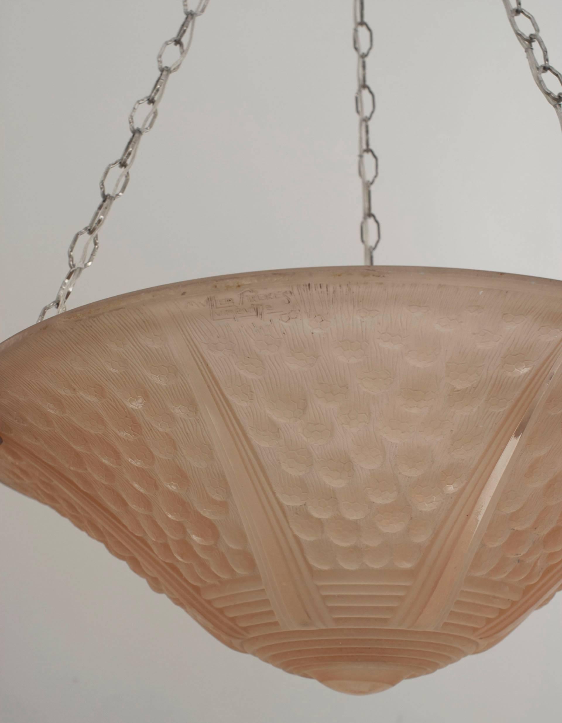 French Art Deco (circa 1925) round pendant form pink tinted glass chandelier with a fluted round bottom and 