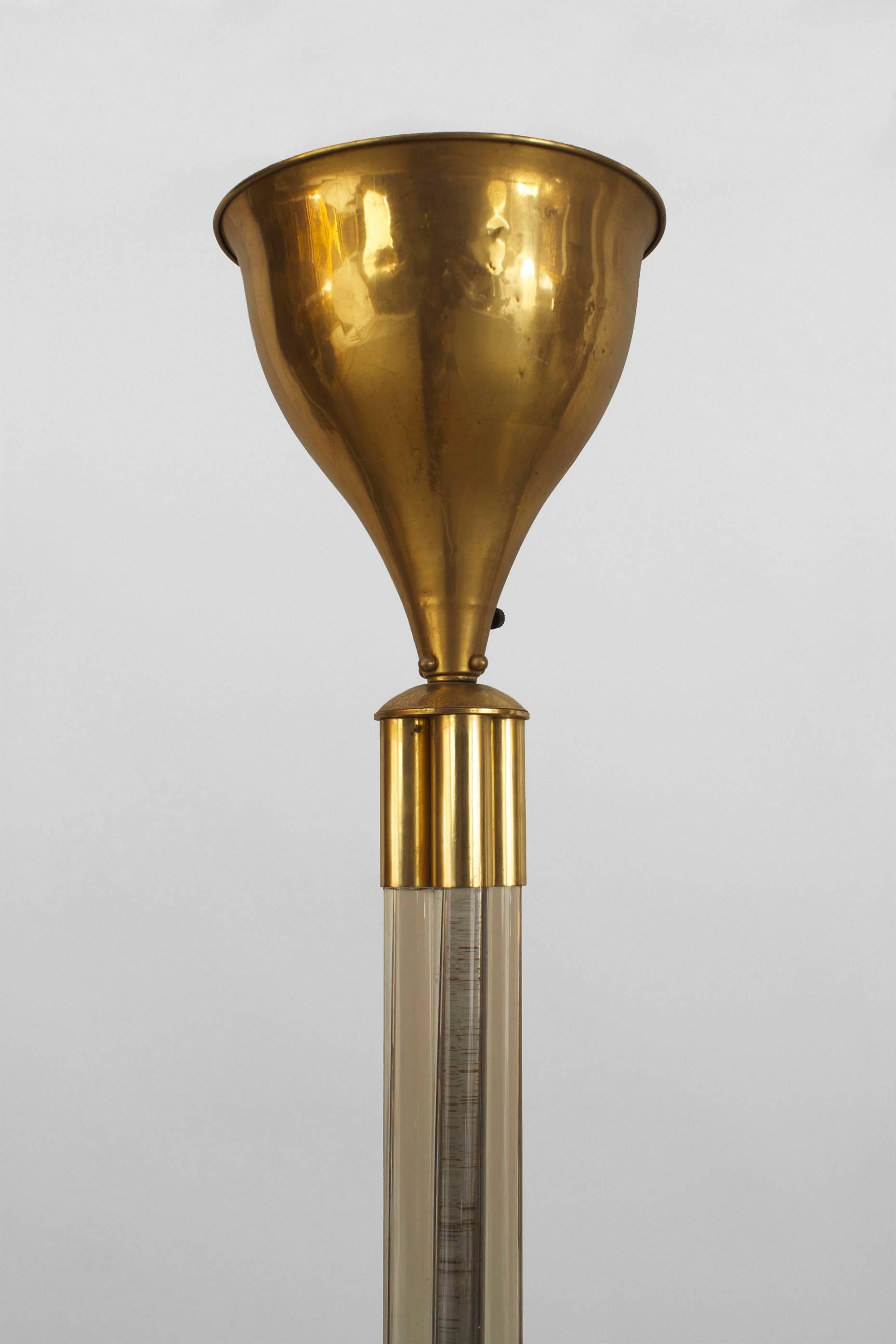 French Art Deco (circa 1930) floor lamp with gilded brass base and uplight and a shaft of 4 tubular lucite rods.
